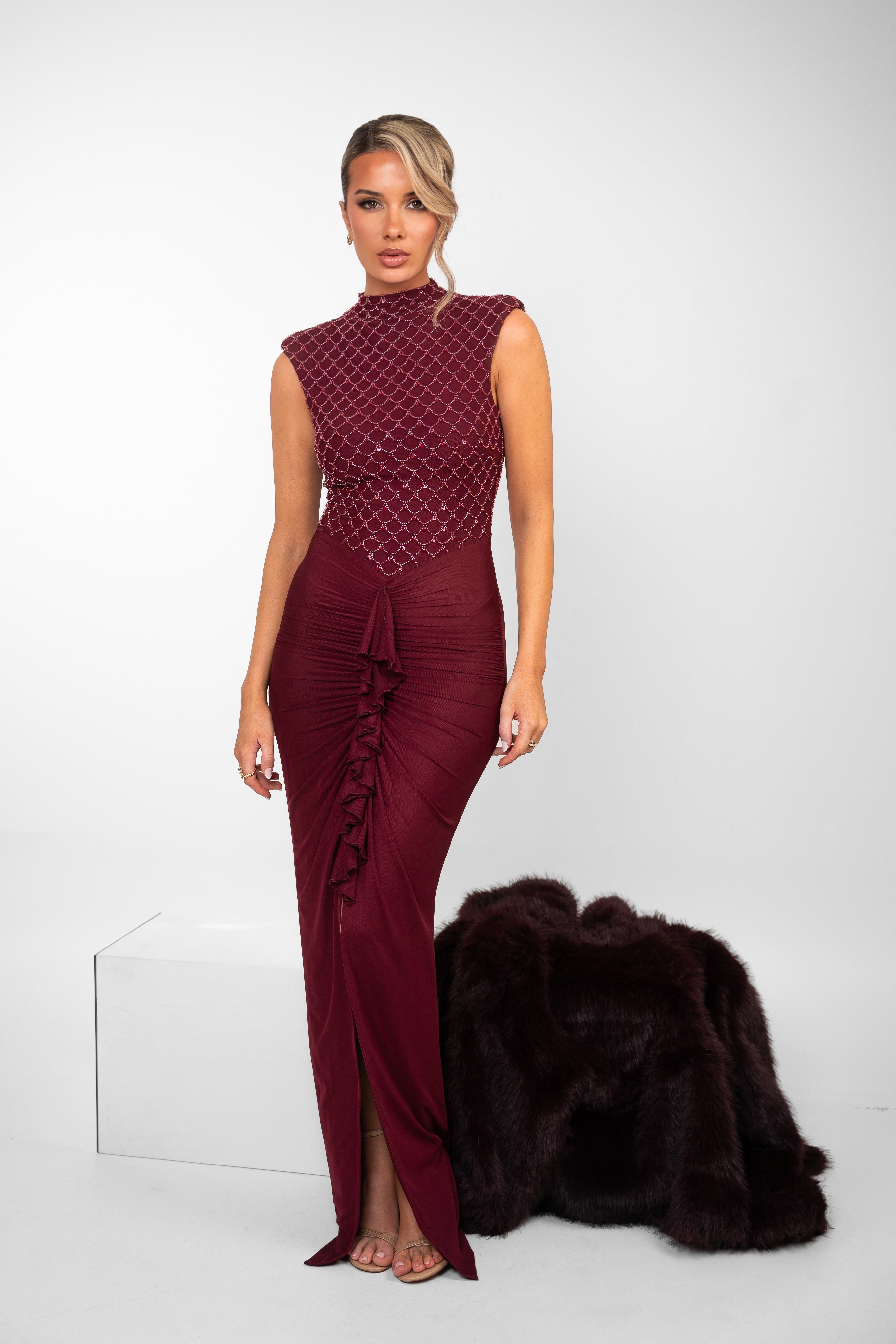 "Floor-length maroon dress with high neckline