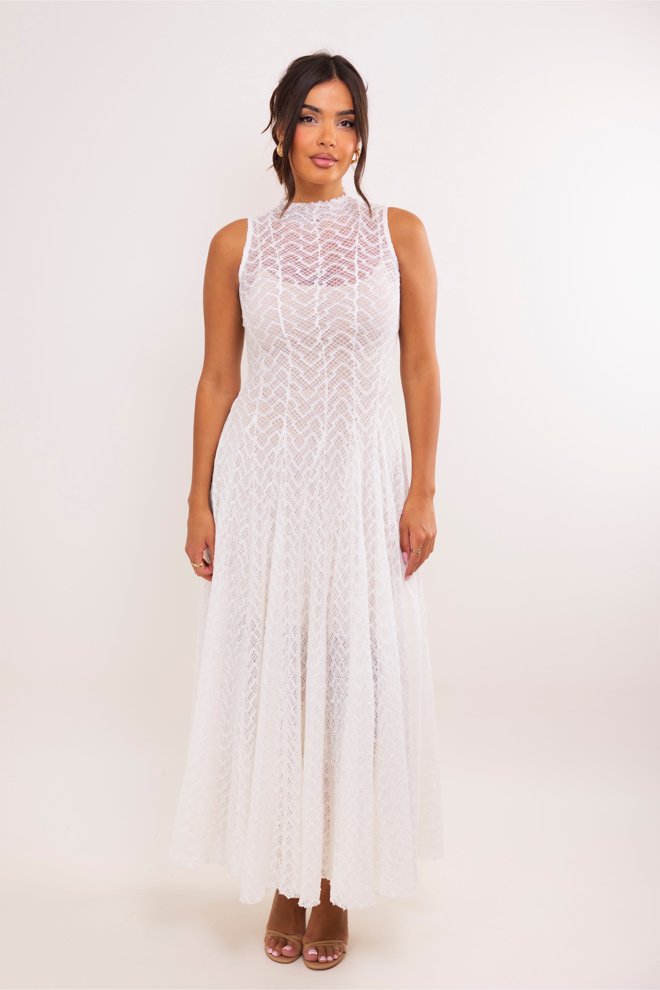 Sleeveless white lace maxi dress with mock neckline and soft A-line skirt