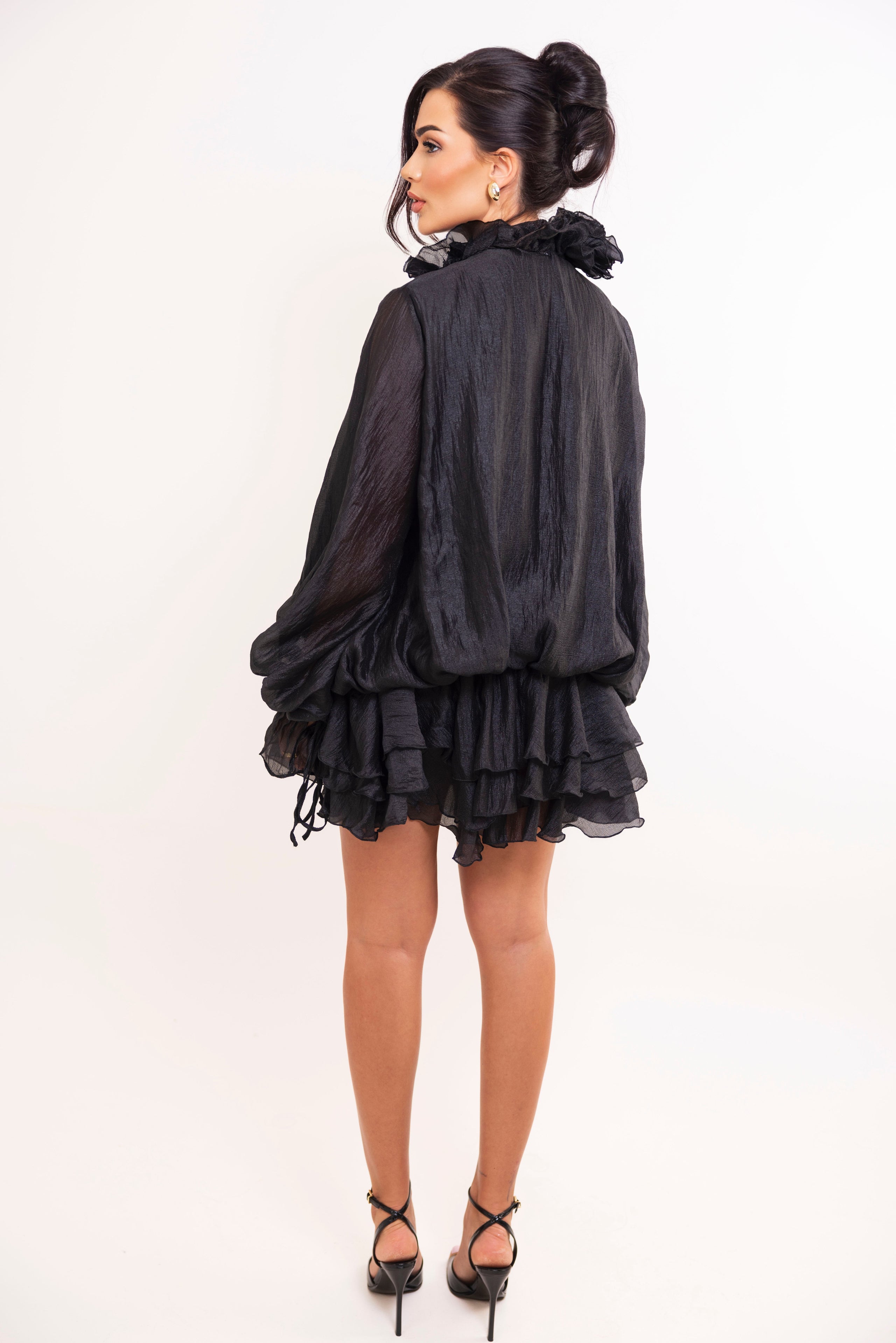 Chic black ruffled mini dress with statement collar and tiered silhouette.