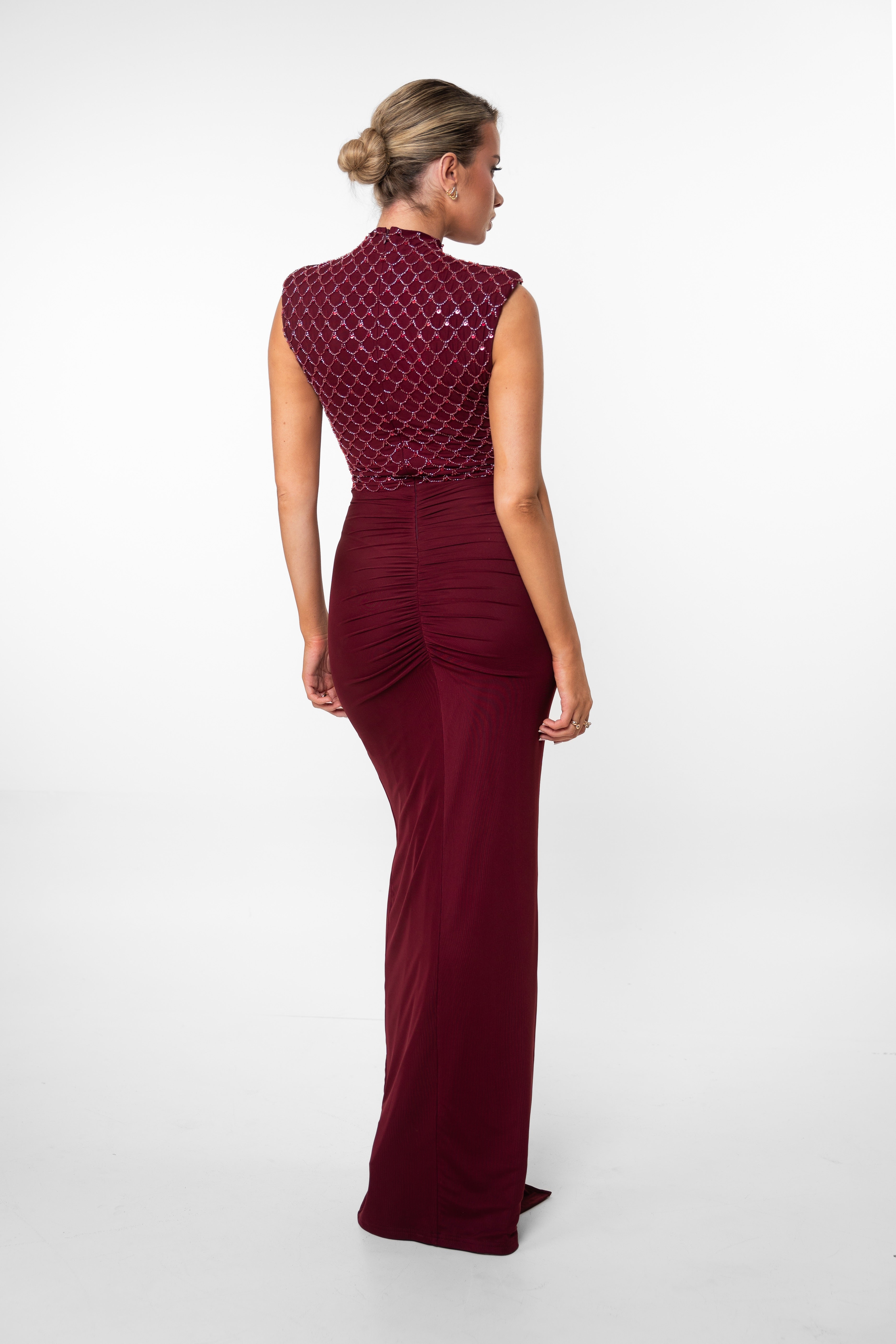 Elegant burgundy dress featuring a patterned bodice and a central ruched ruffle