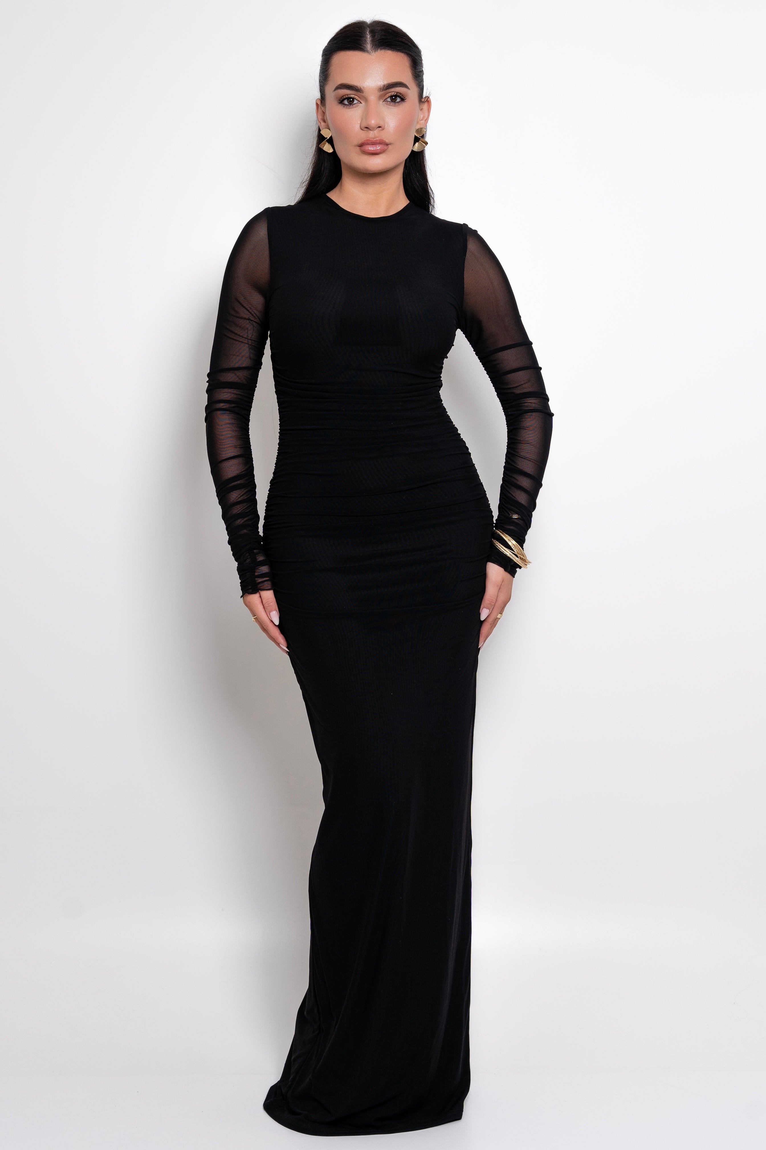 Elegant black evening dress with sheer long sleeves and a fitted silhouette