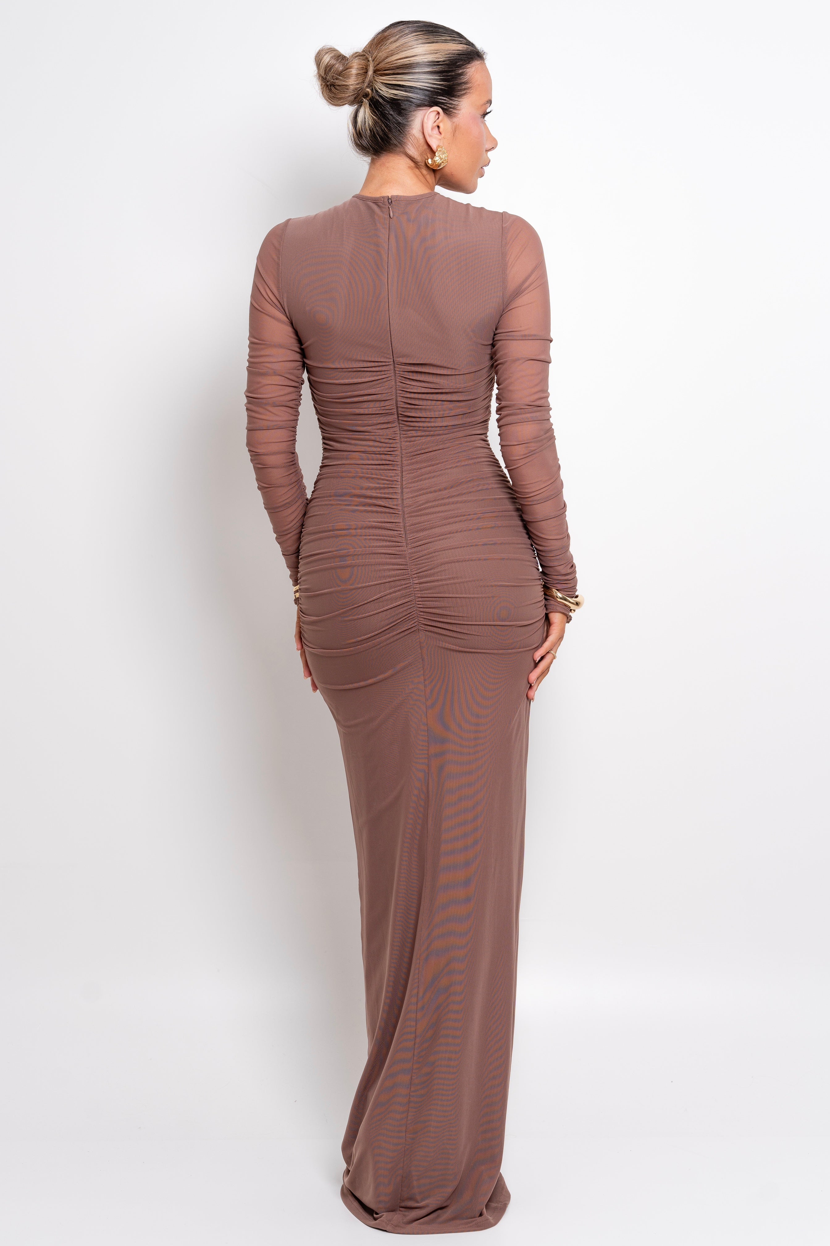 Chic taupe-toned evening dress with sheer accents and a form-fitting design