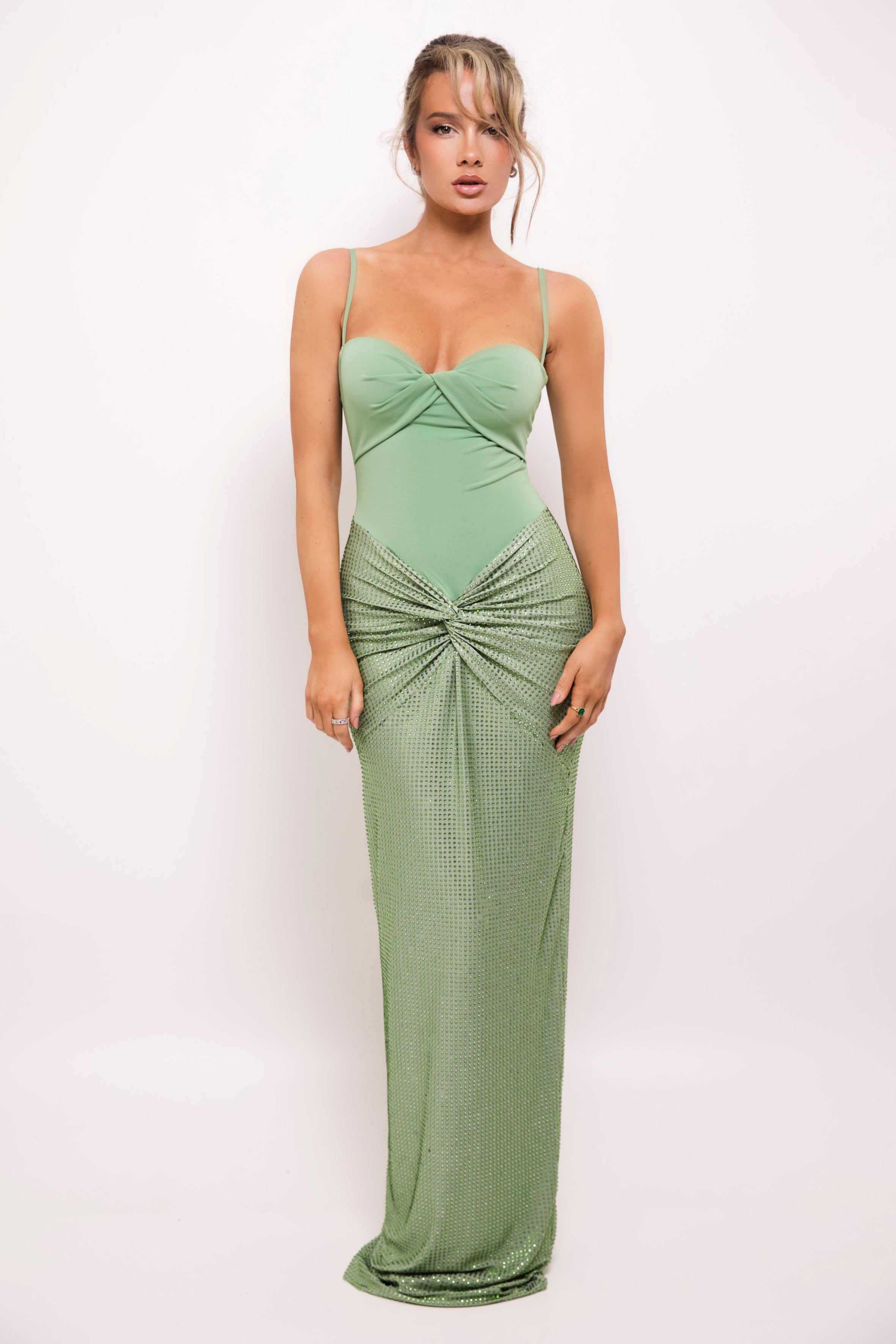 Graceful long gown in muted green, featuring a sophisticated sequined design, sweetheart neckline, and scarf accent