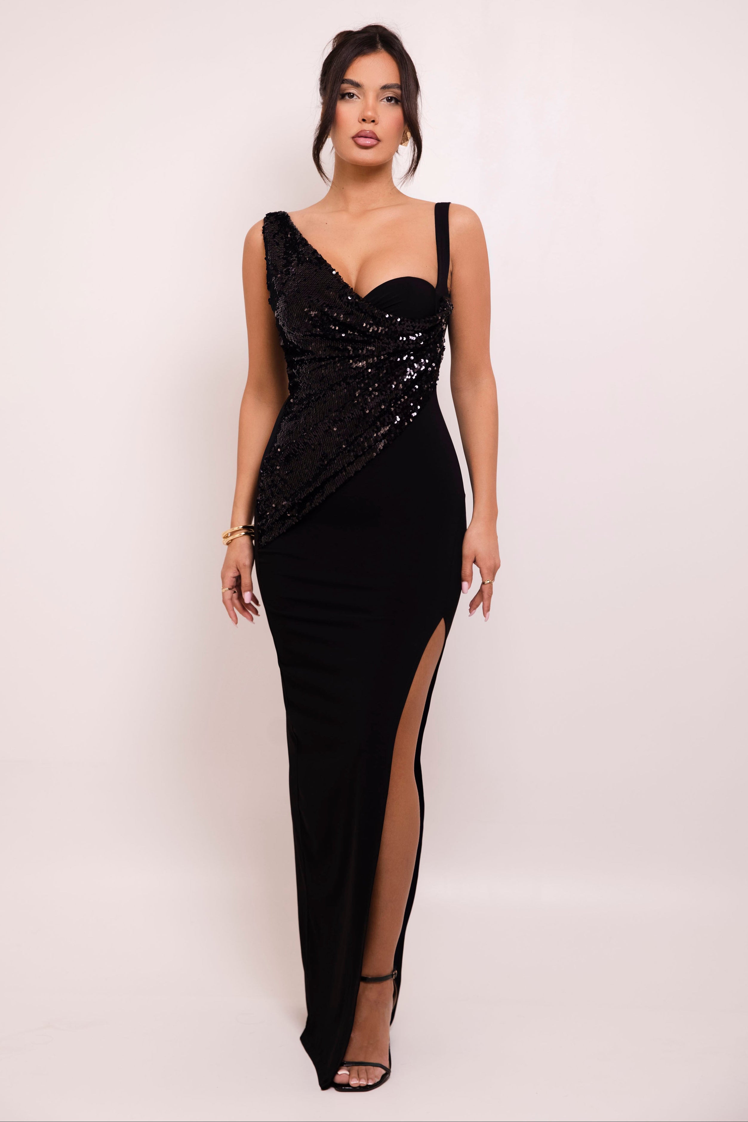 Elegant black evening gown with shimmering asymmetrical sequin draping and a chic thigh-high slit