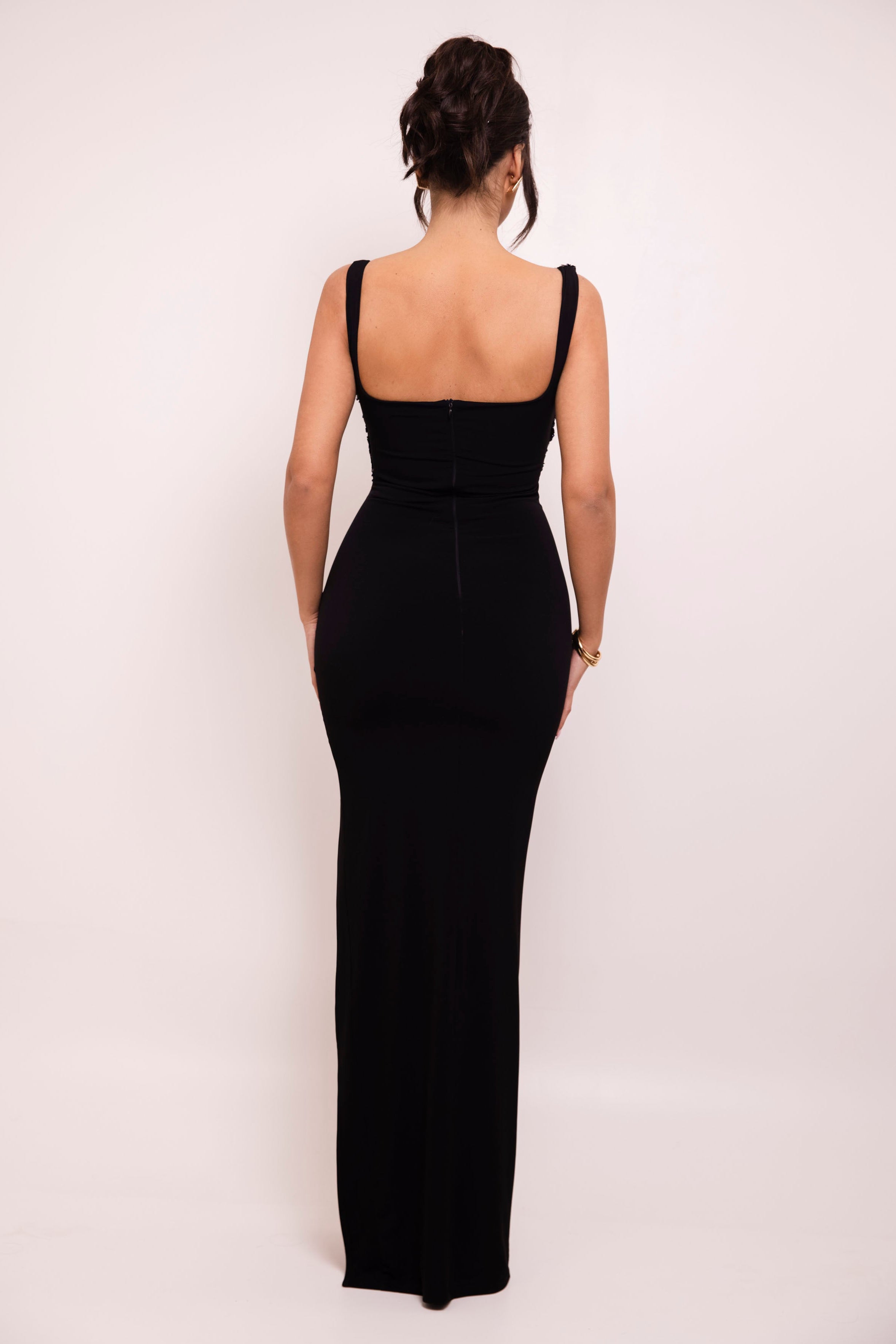 Stylish one-shoulder black gown showcasing an elegant sequined bodice detail and dramatic side slit.