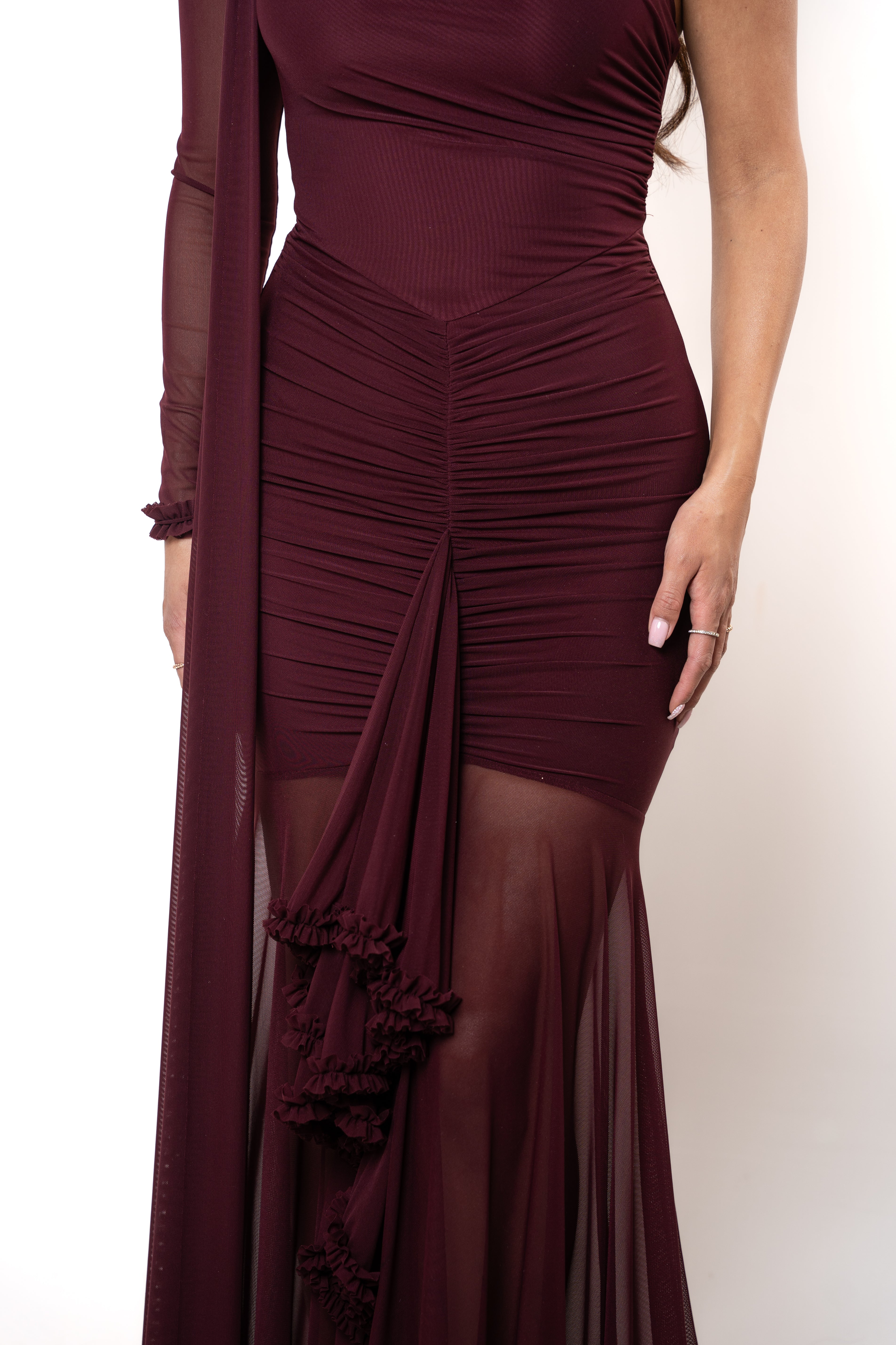Maroon evening gown with sheer overlay on a white background