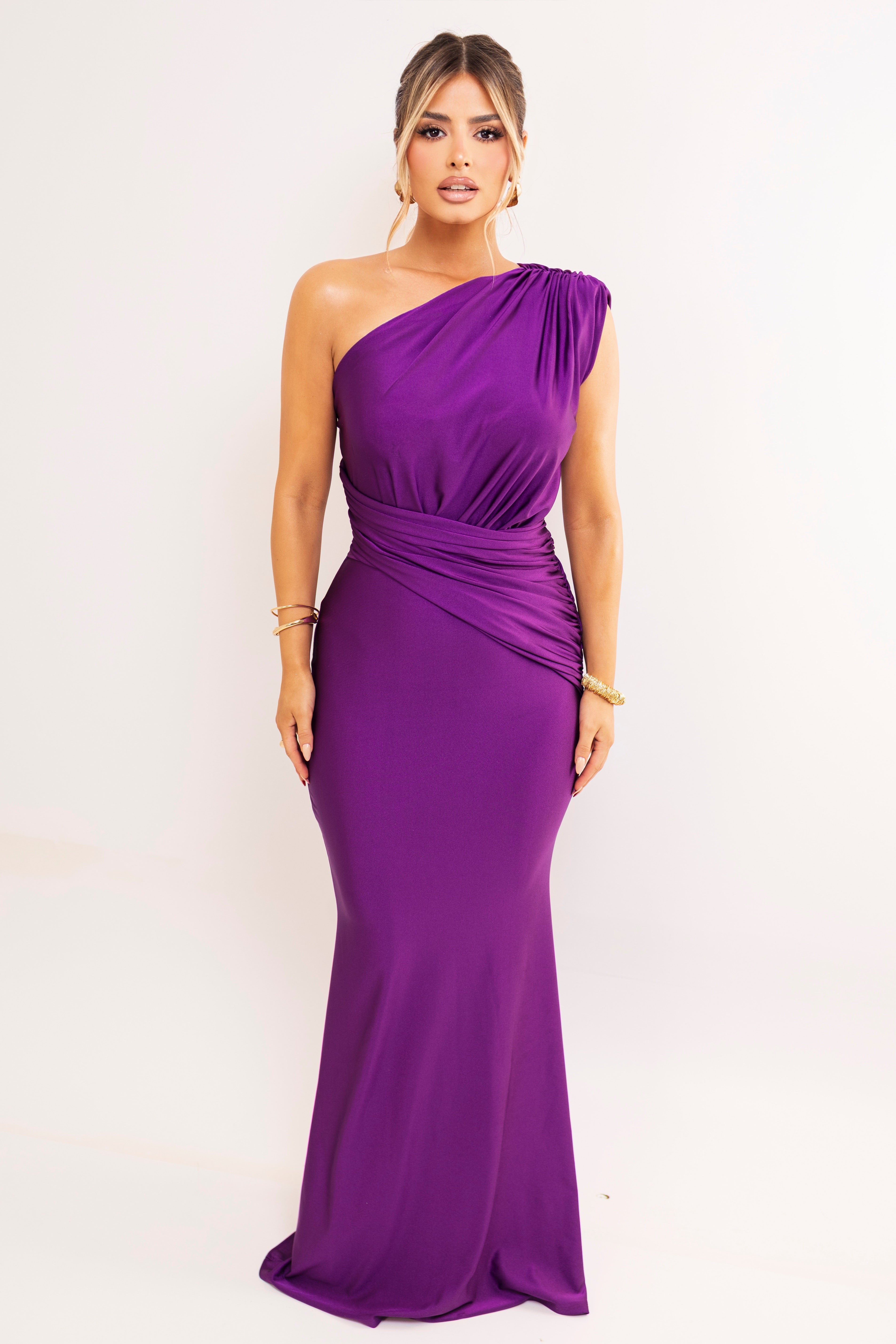 Purple one-shoulder gown with ruched waist.