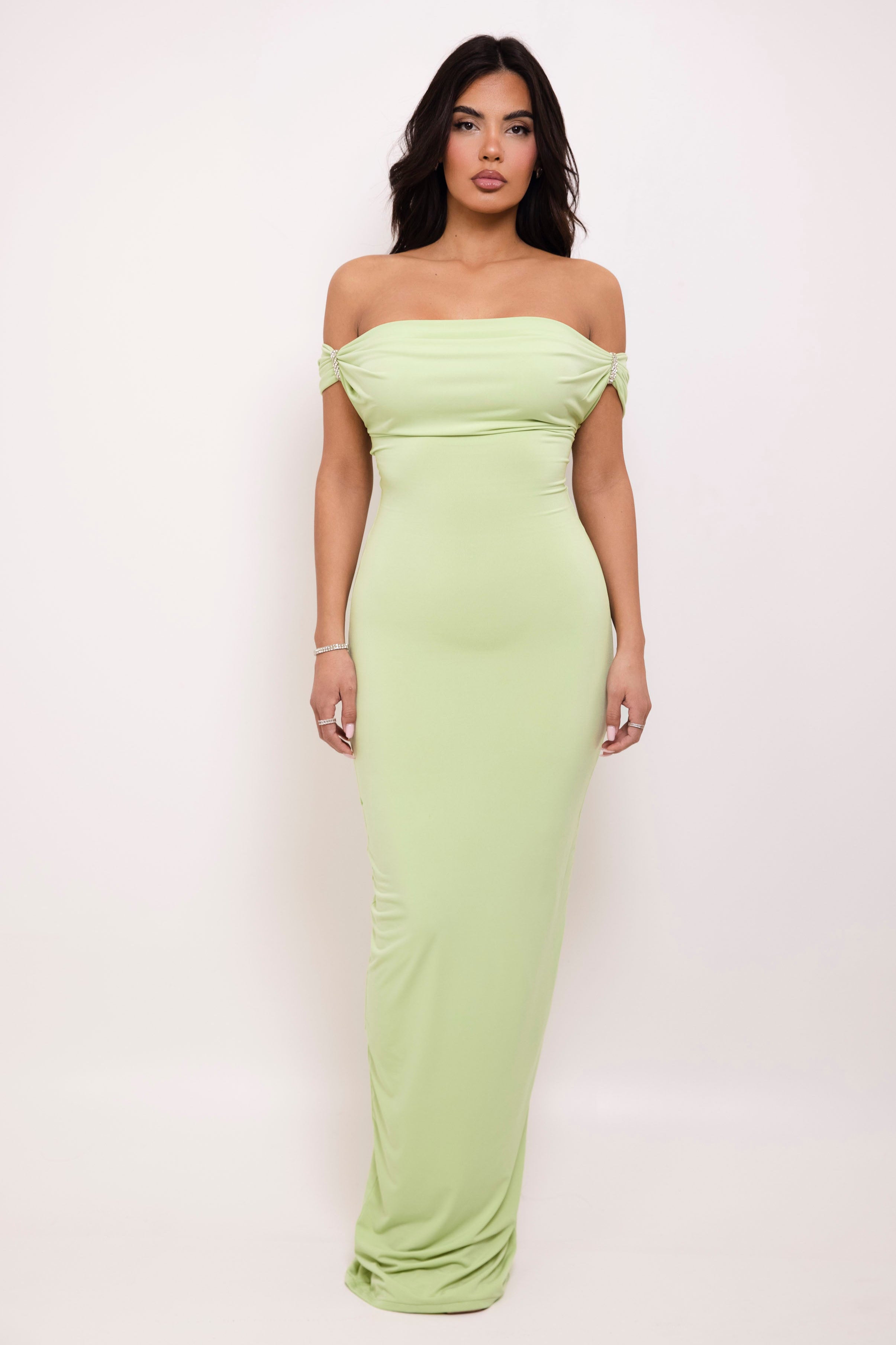 Elegant off-the-shoulder pastel green gown with subtle draping details
