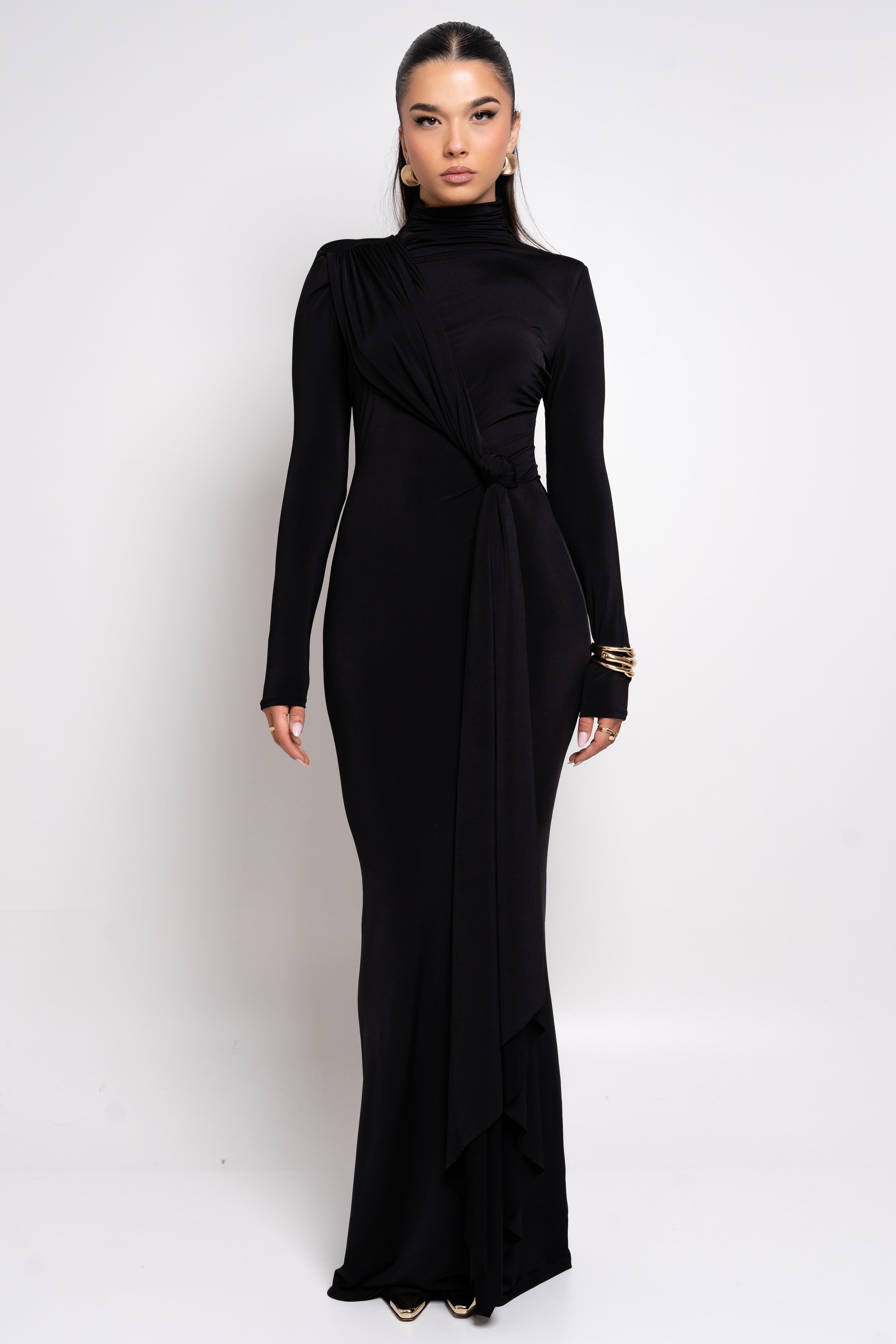 Elegant black long-sleeve gown with a high neckline and waist tie.