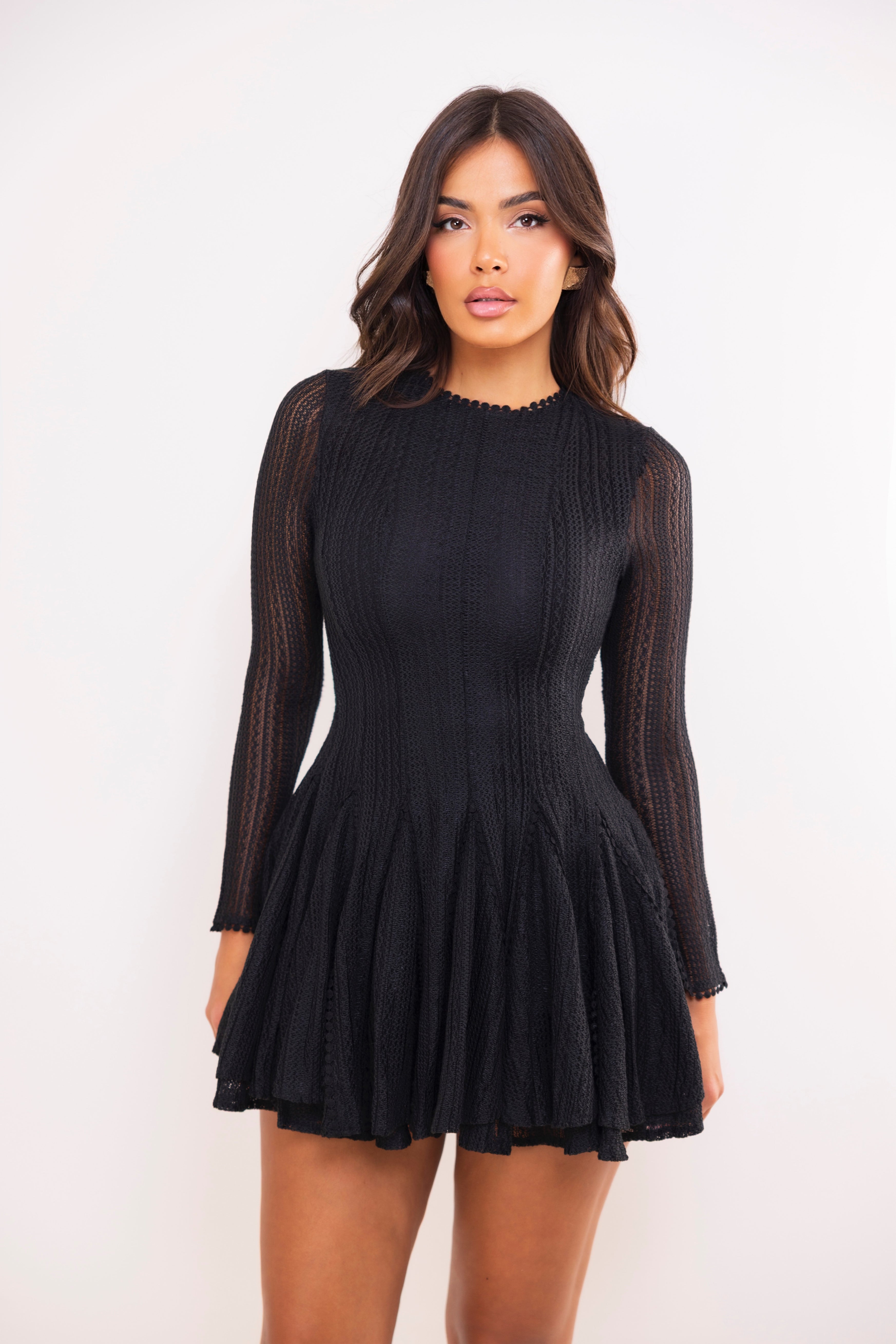 Woman wearing a black dress against a white background