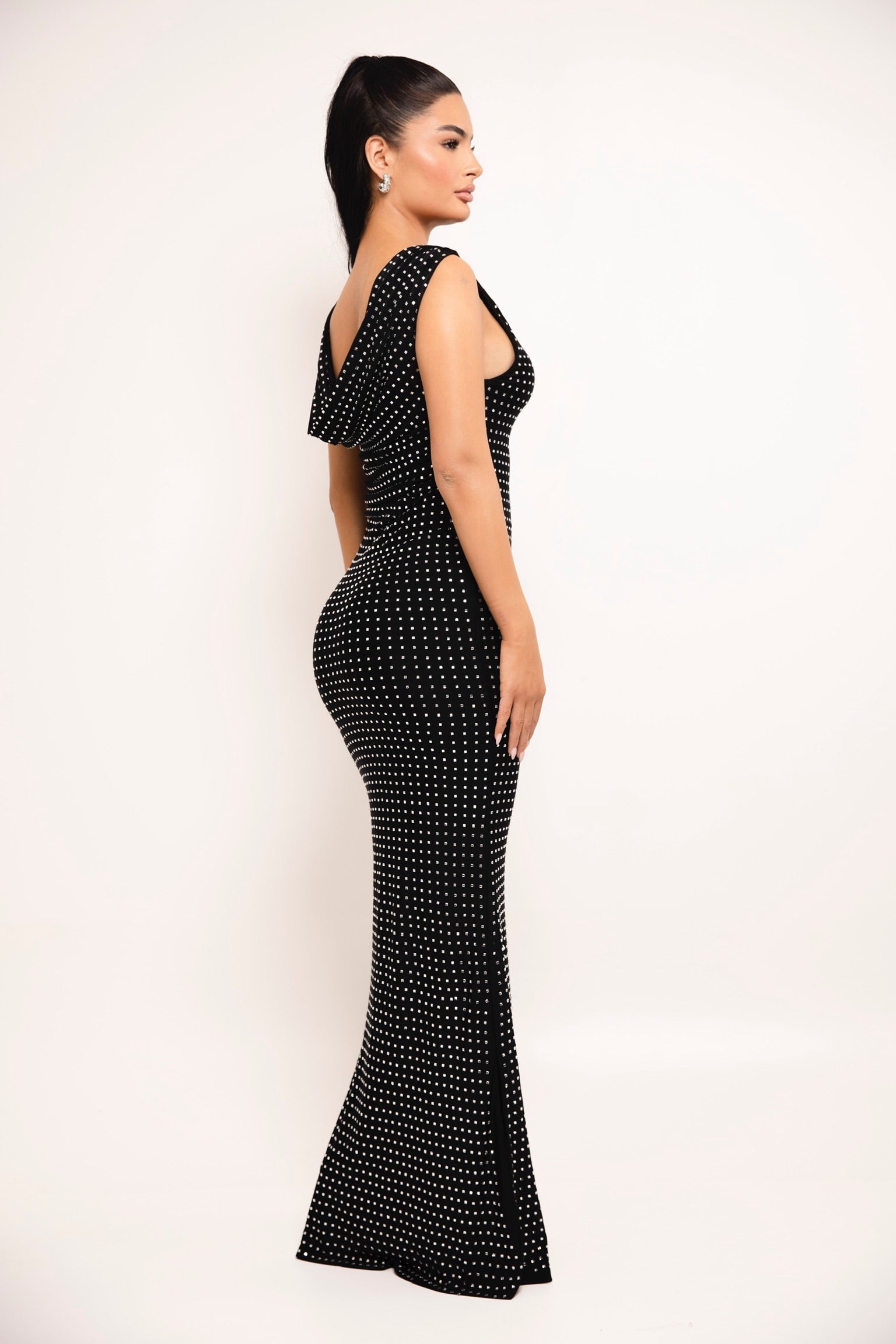 Floor-length black dress featuring a plunging neckline and dotted sparkle design.