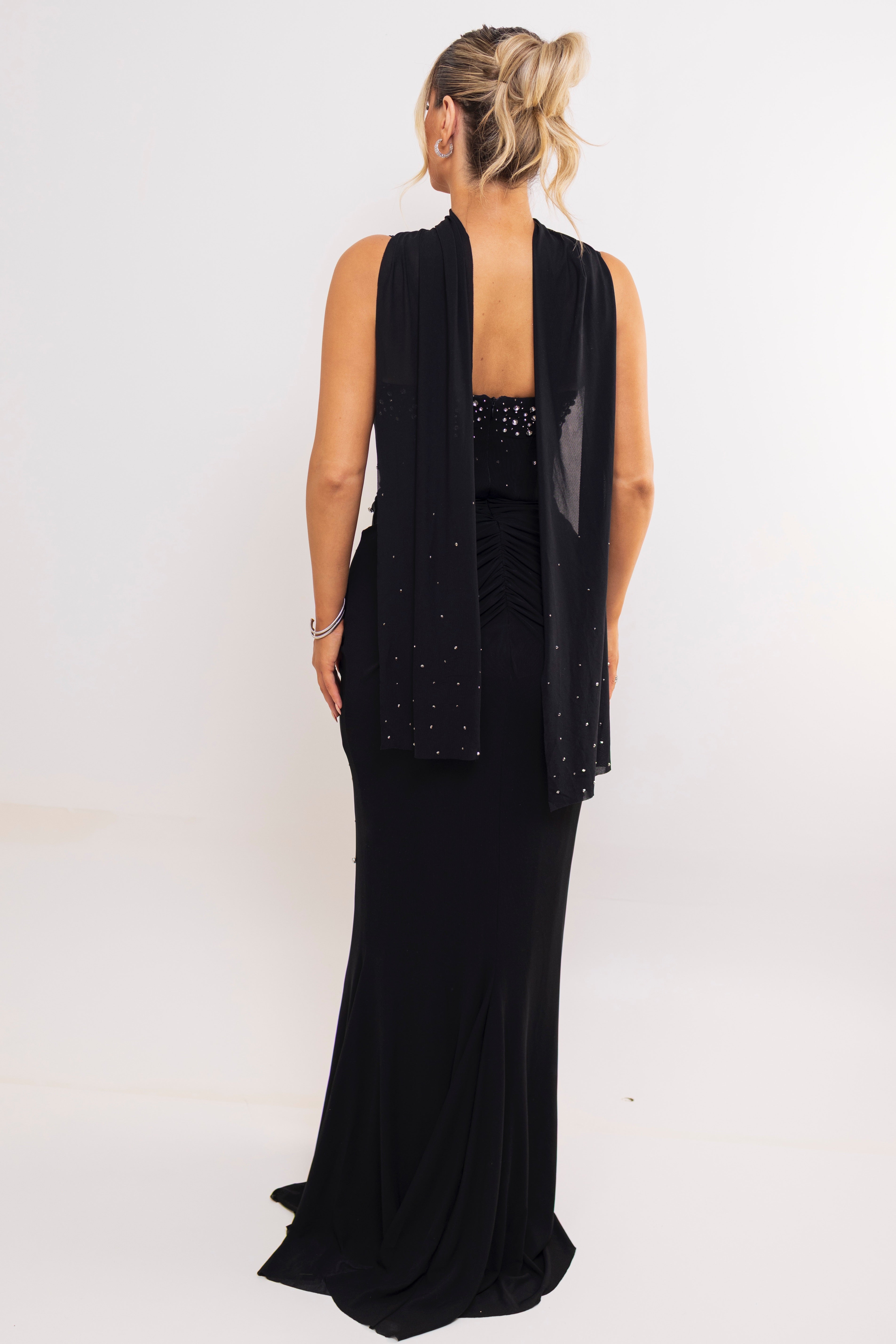 Back view of glittery halter dress with low open back.