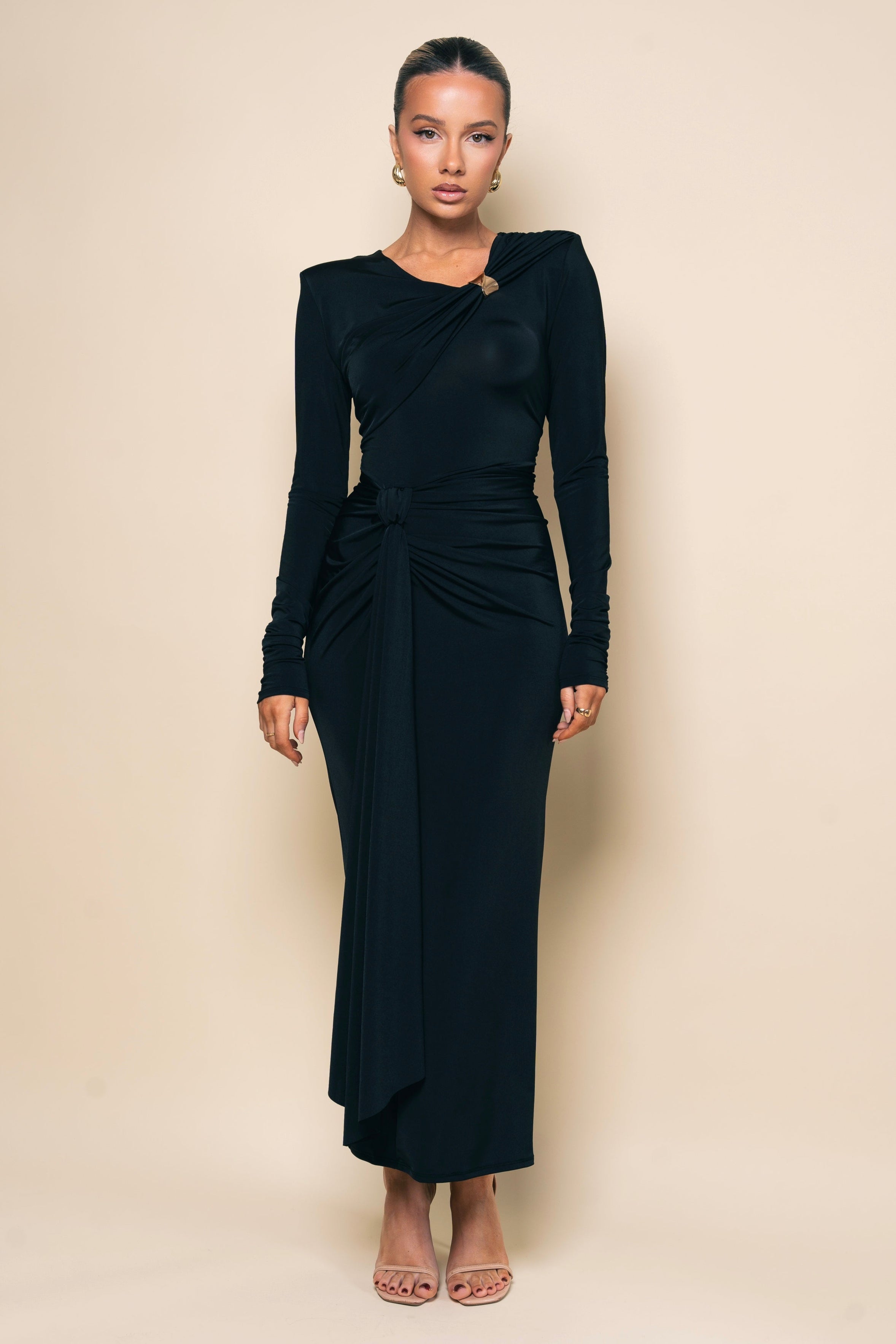 Chic black dress with long sleeves and a twist knot at the waist.
