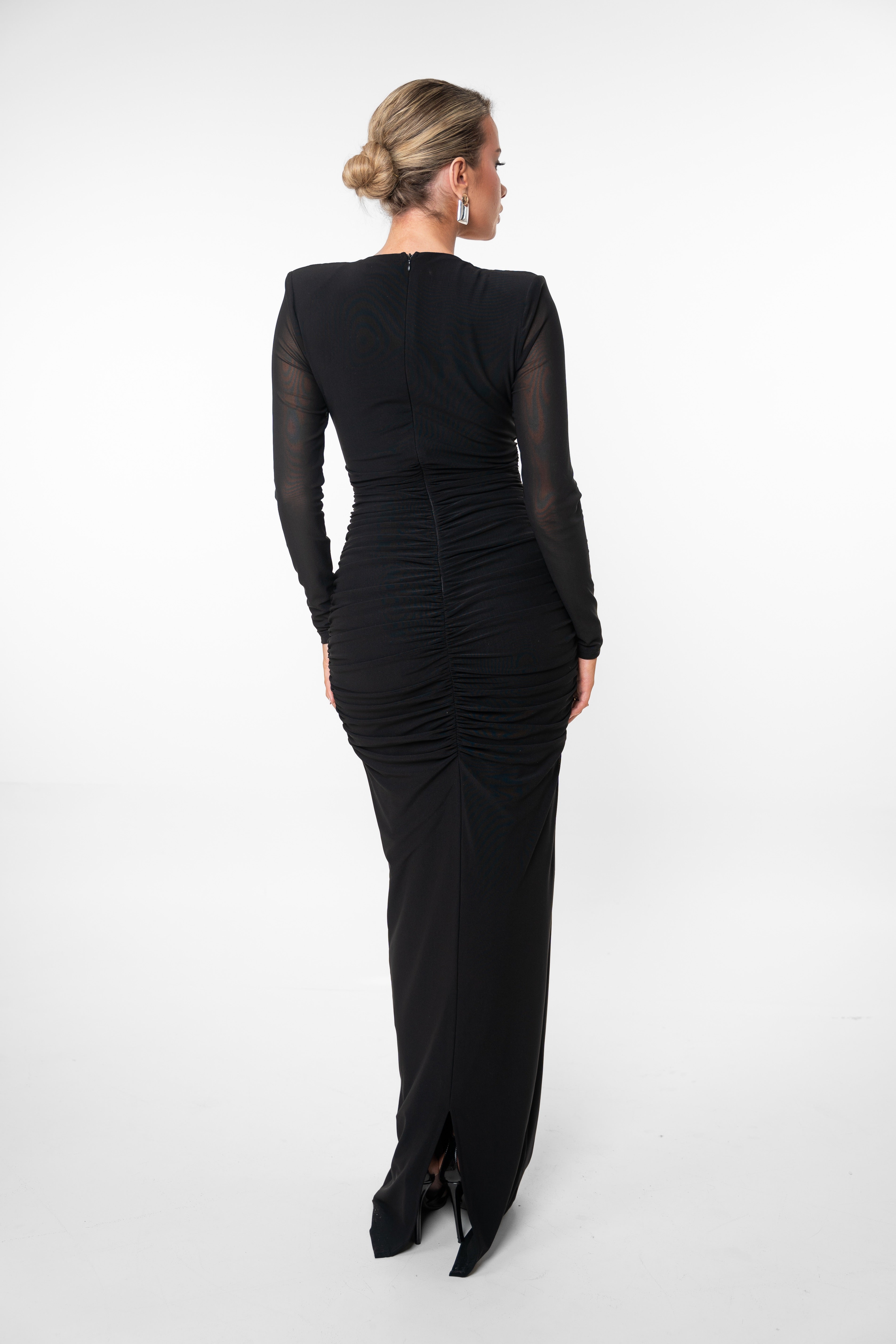 Woman wearing a black evening gown on a white background