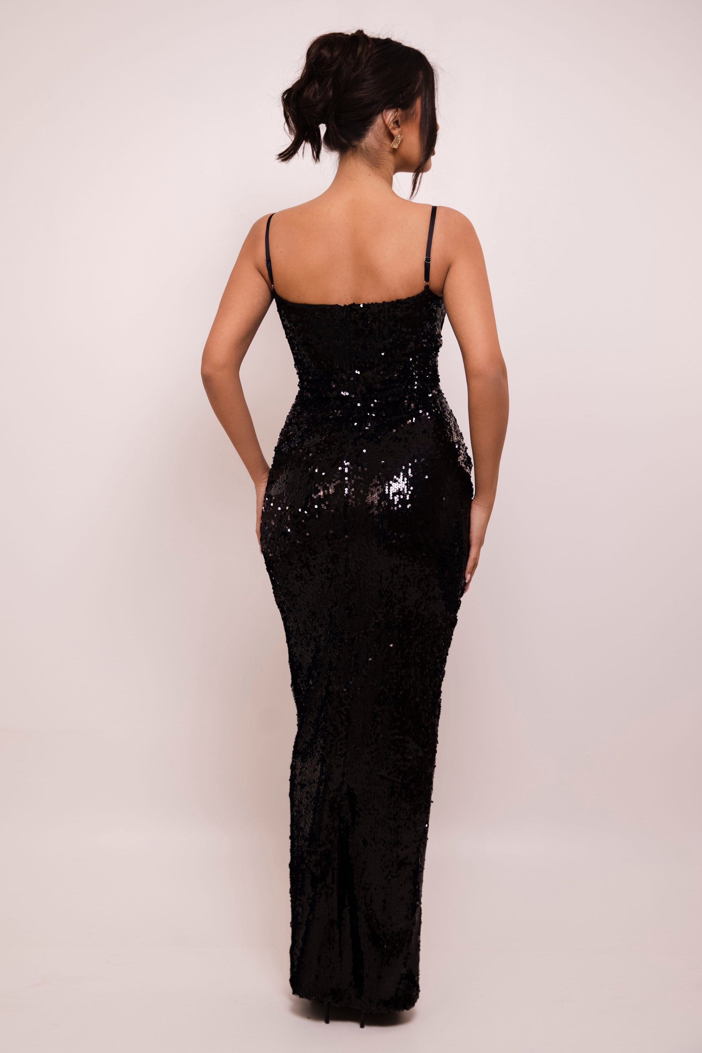 Luxurious black sequin prom dress showcasing a feminine silhouette and elegant bust detailing.