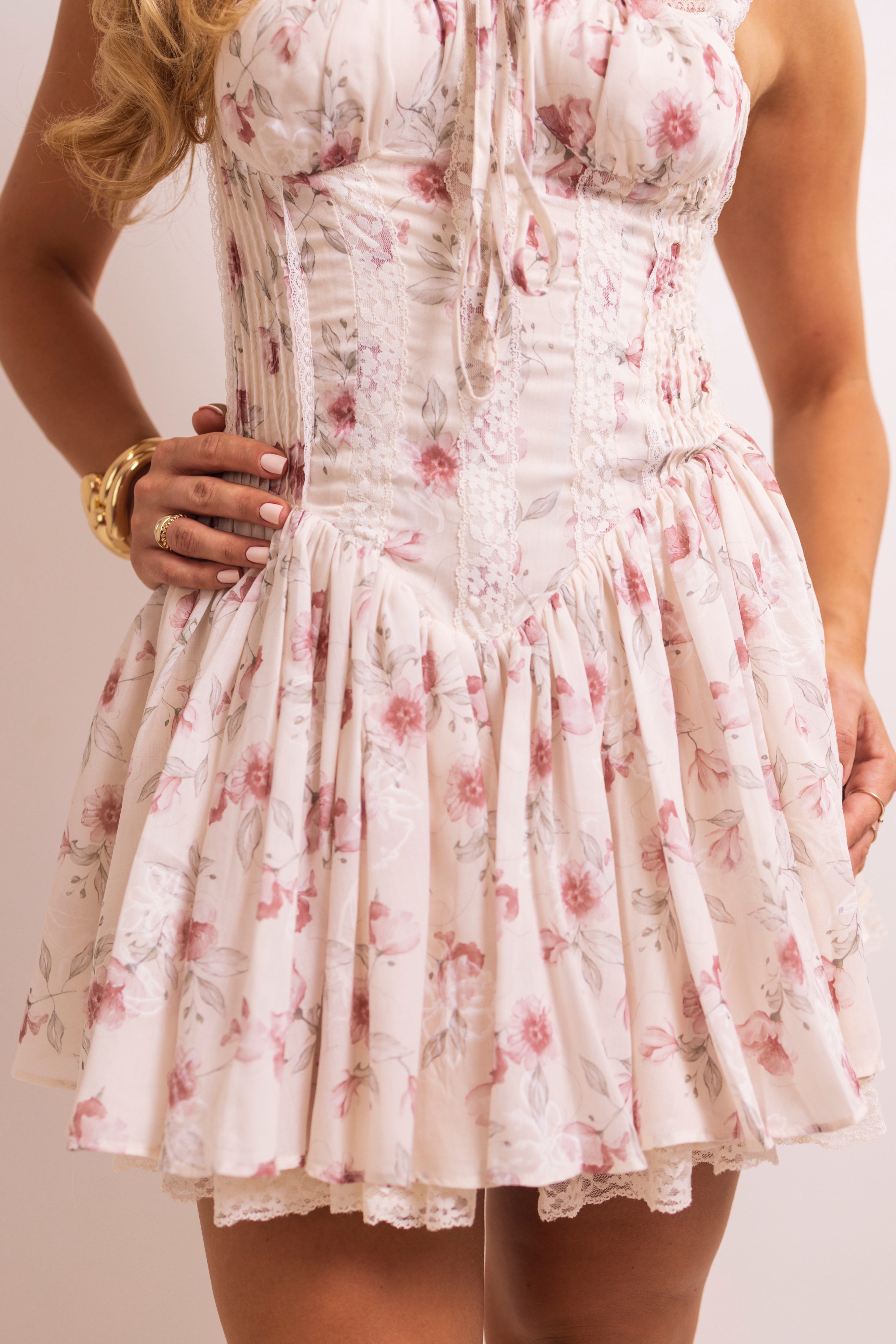 Floral print on a dress with lace detailing at the hem.