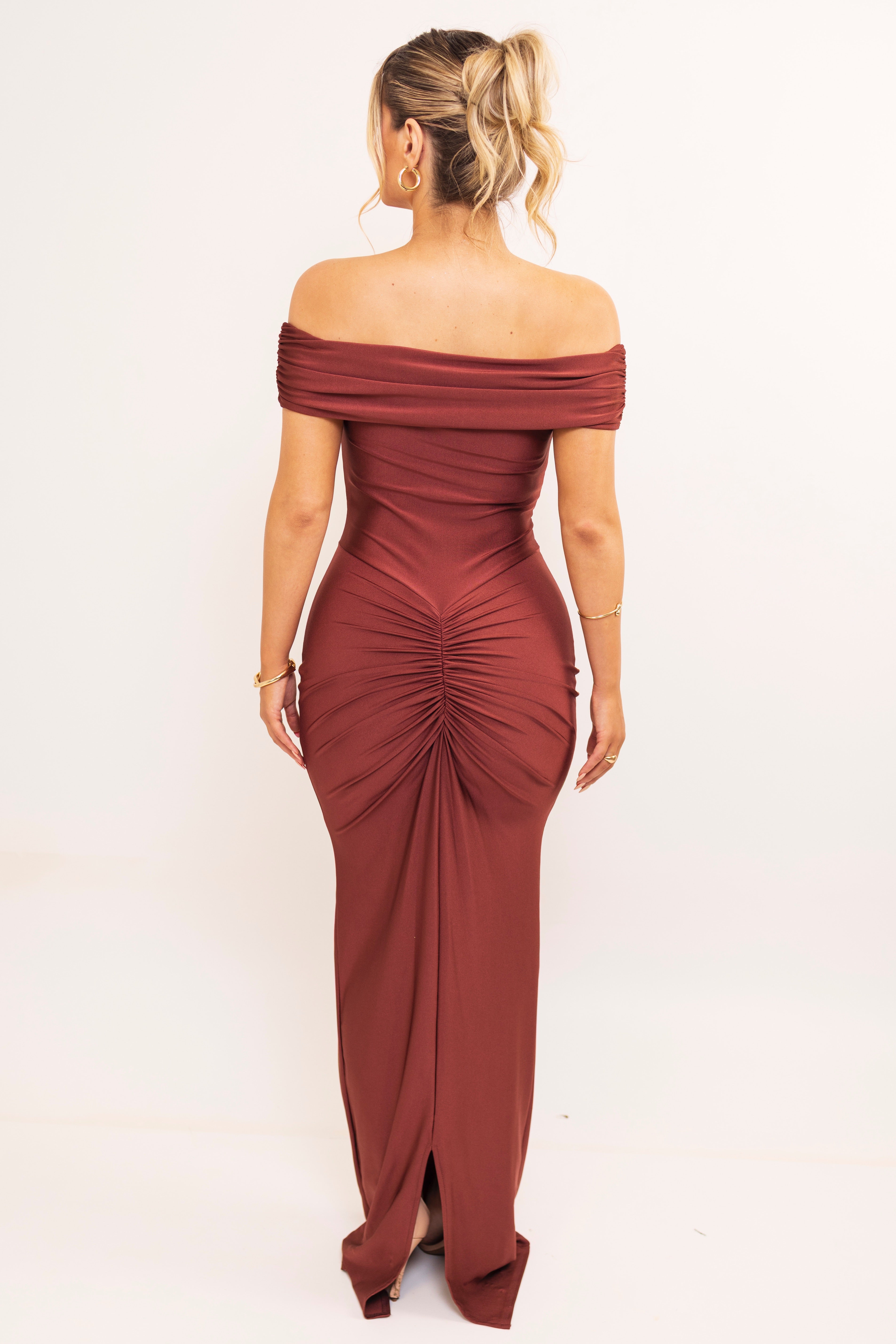 Back view of ruched off-shoulder red-brown gown.