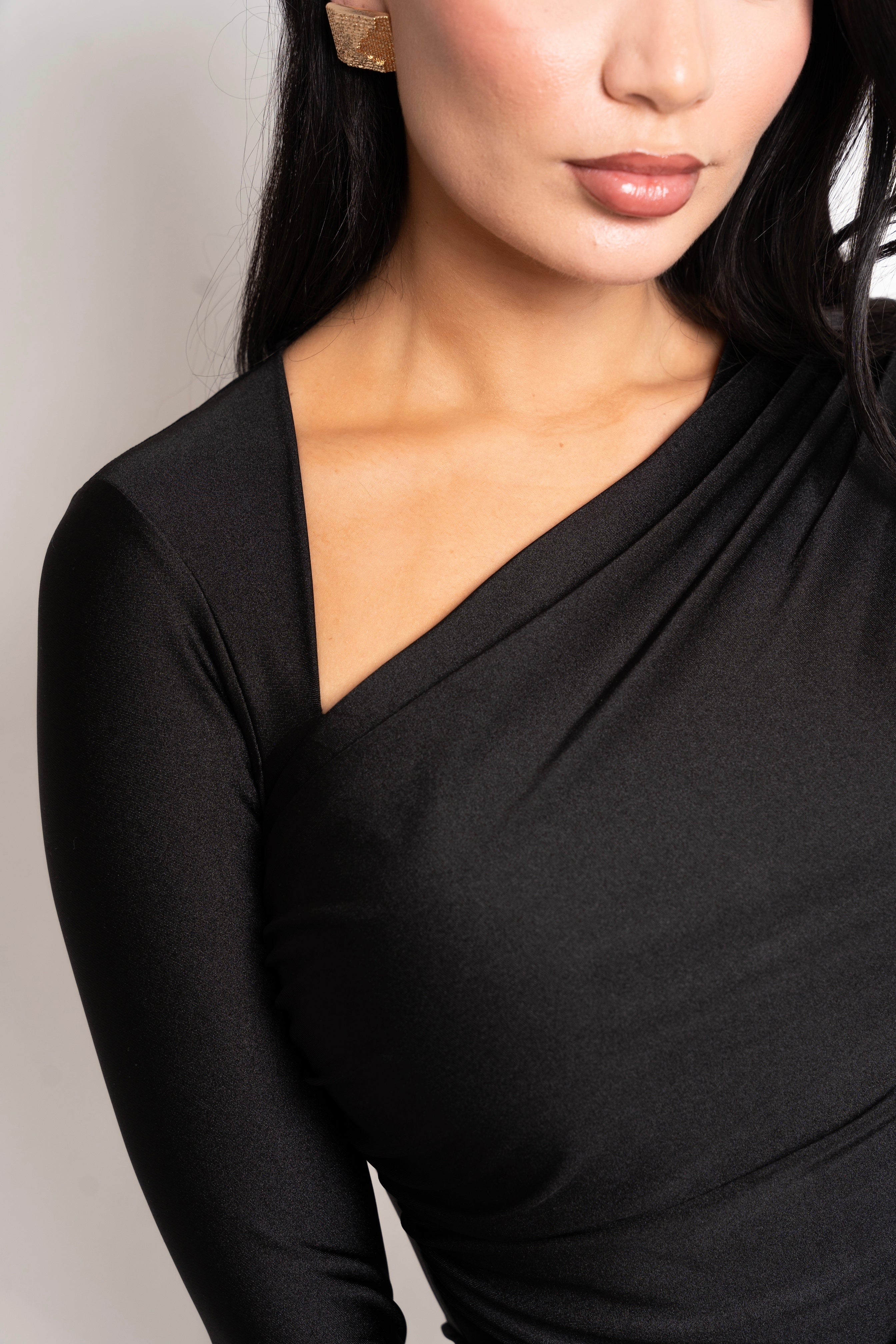 Body-hugging black maxi with a draped, ruched waistline.