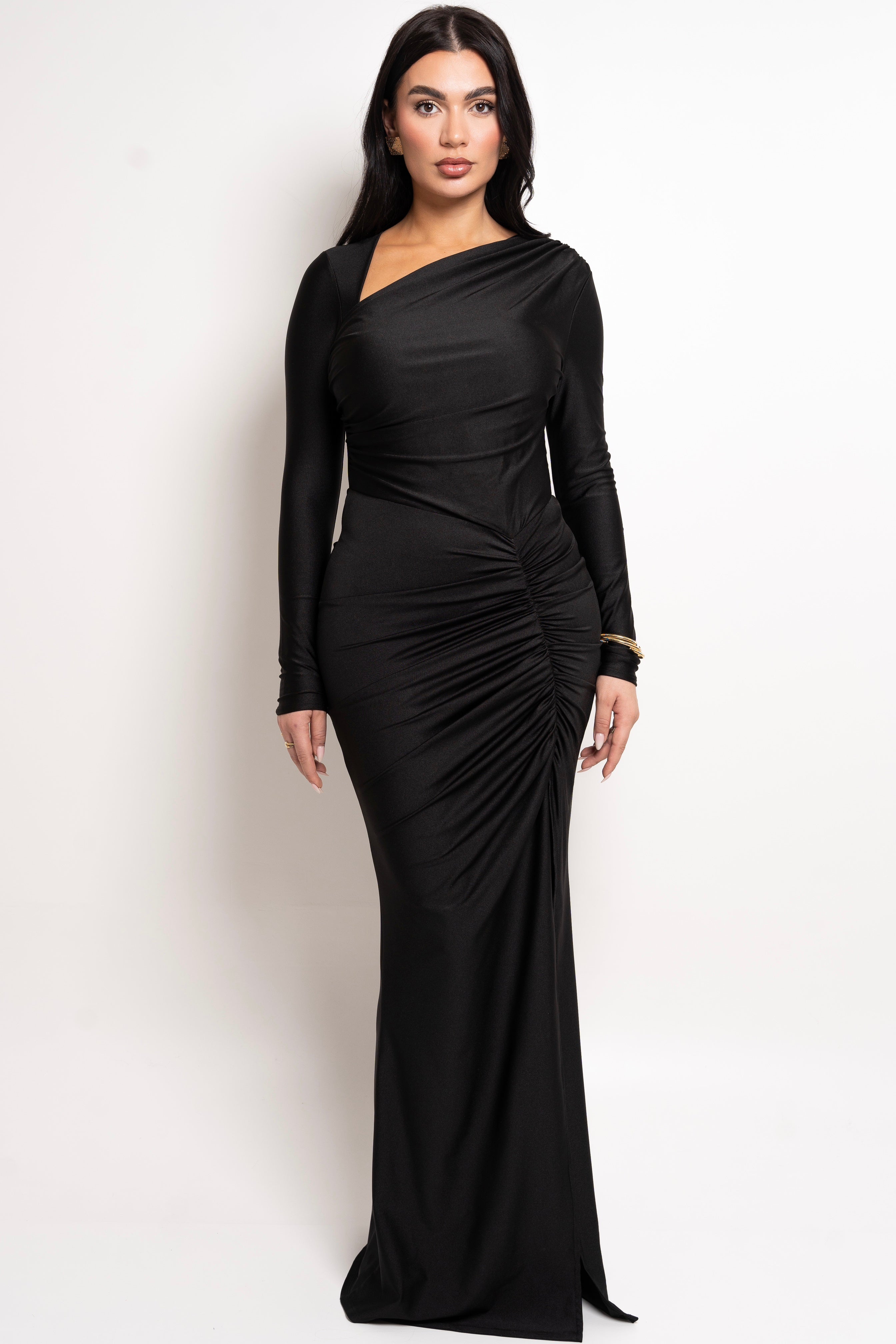 Long-sleeve black maxi dress with an asymmetric neckline.