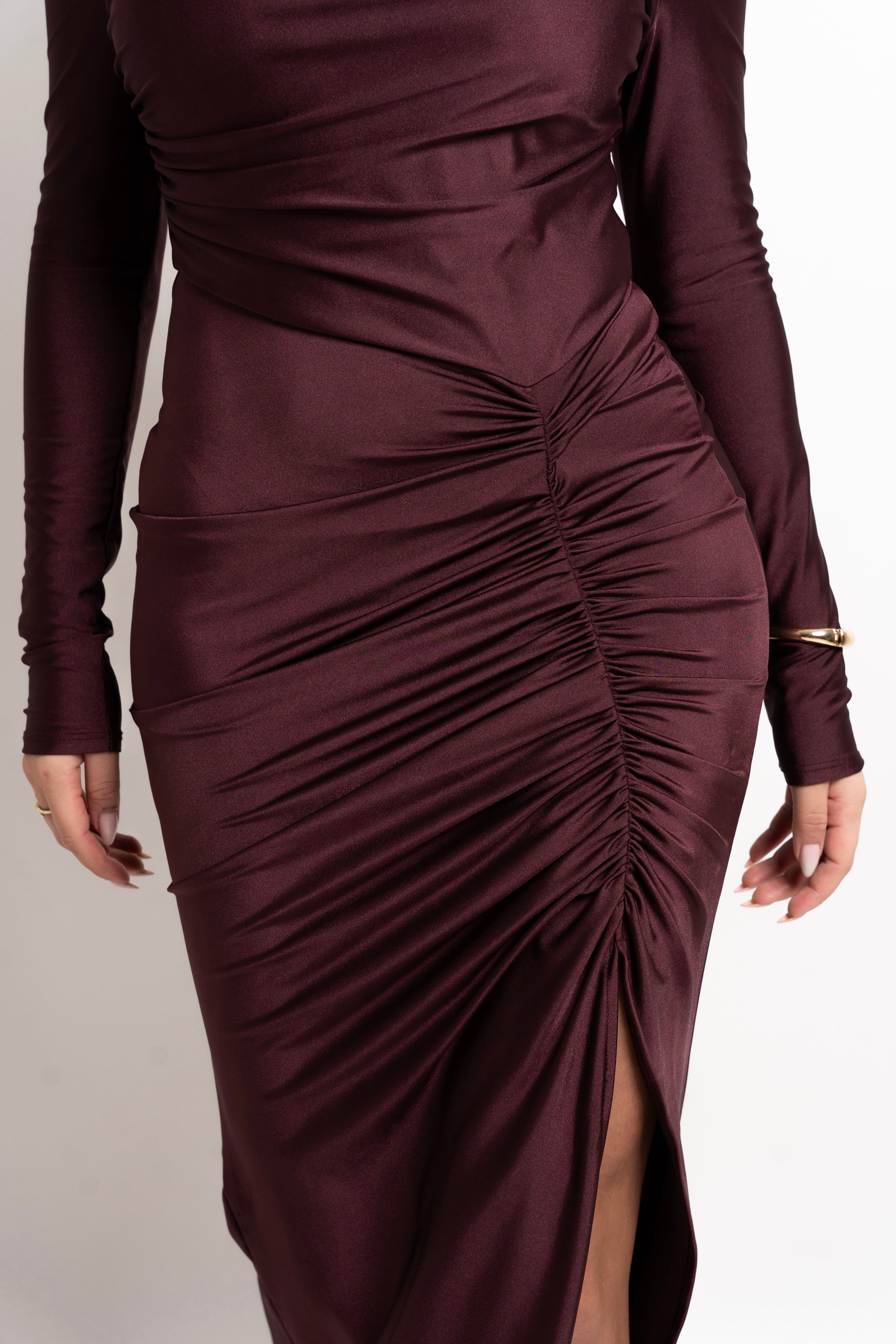 Elegant burgundy dress with side gathers and a contoured silhouette.