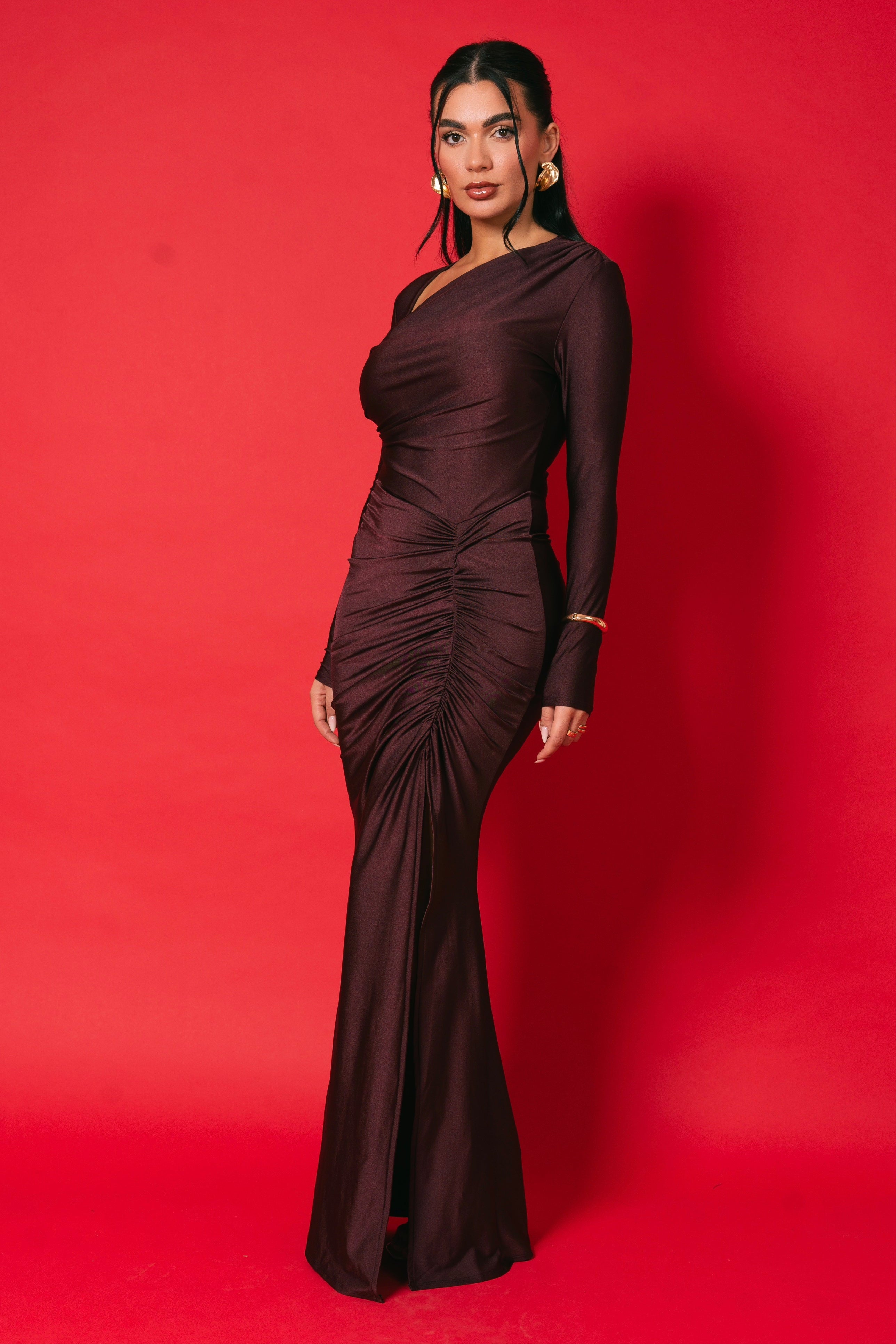 Body-hugging burgundy maxi showcasing a sleek, ruched front.