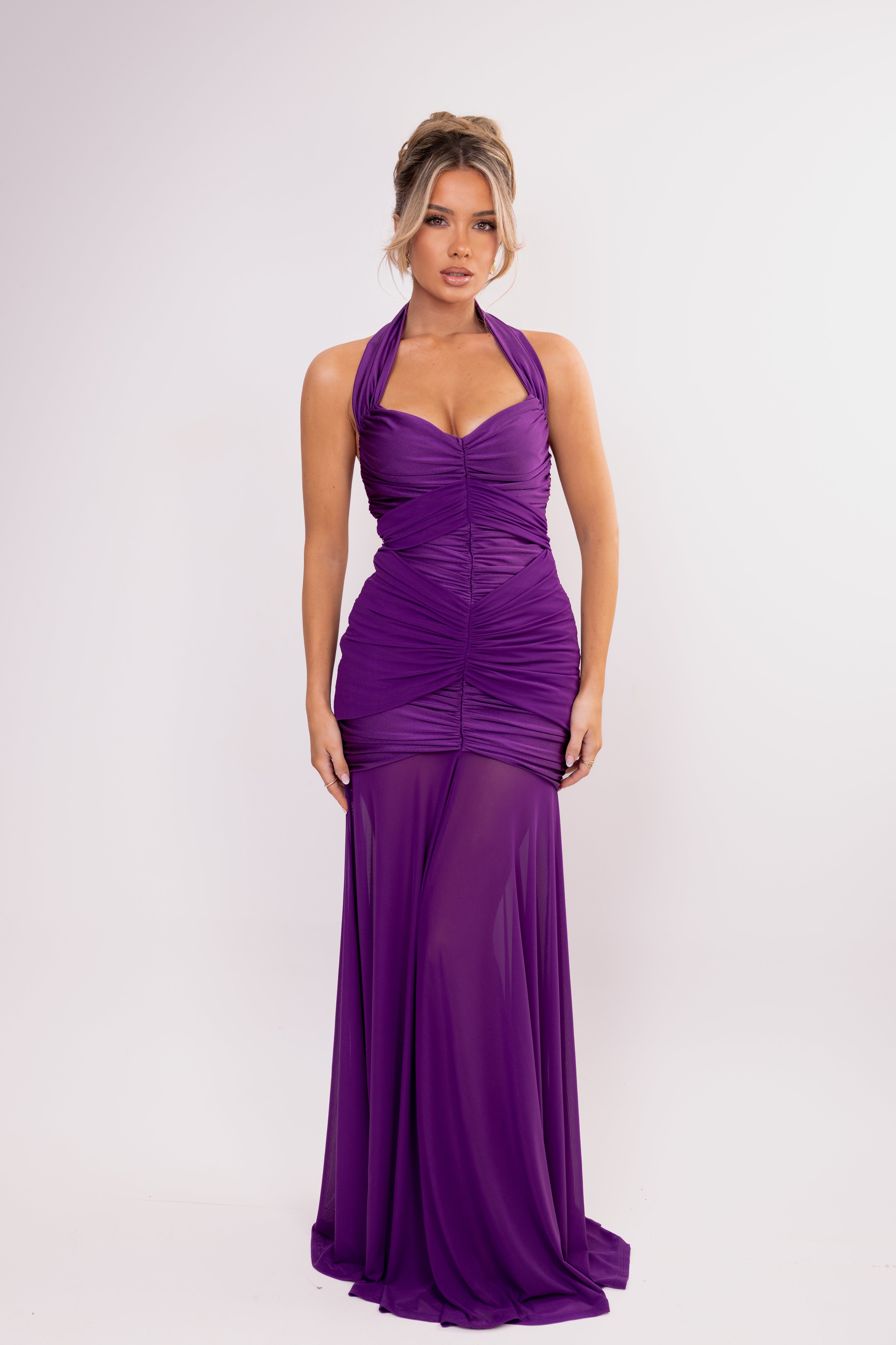 Woman wearing a purple evening gown on a white background