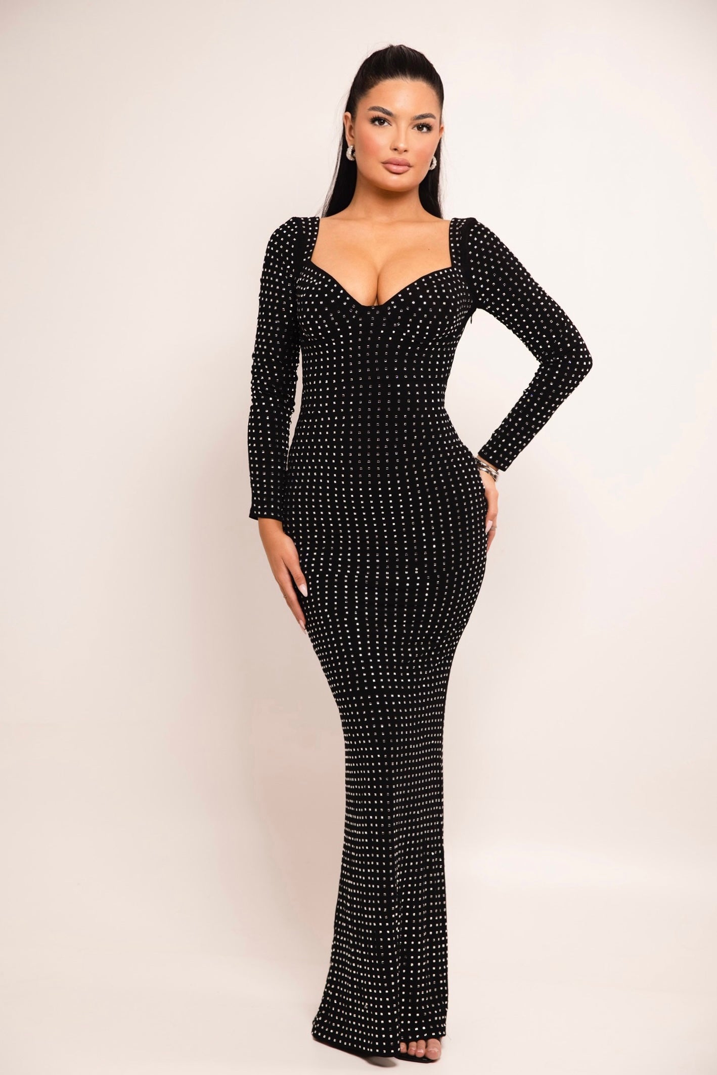 Black studded gown with sweetheart neckline and long sleeves.