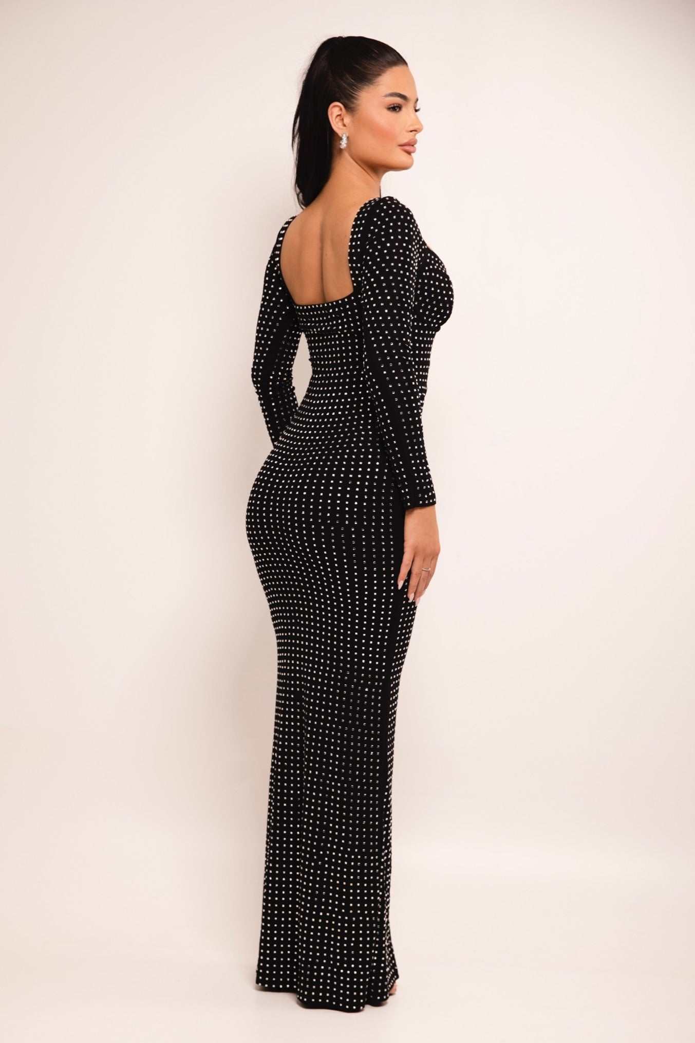 Curve-hugging black evening dress with rhinestone detailing.