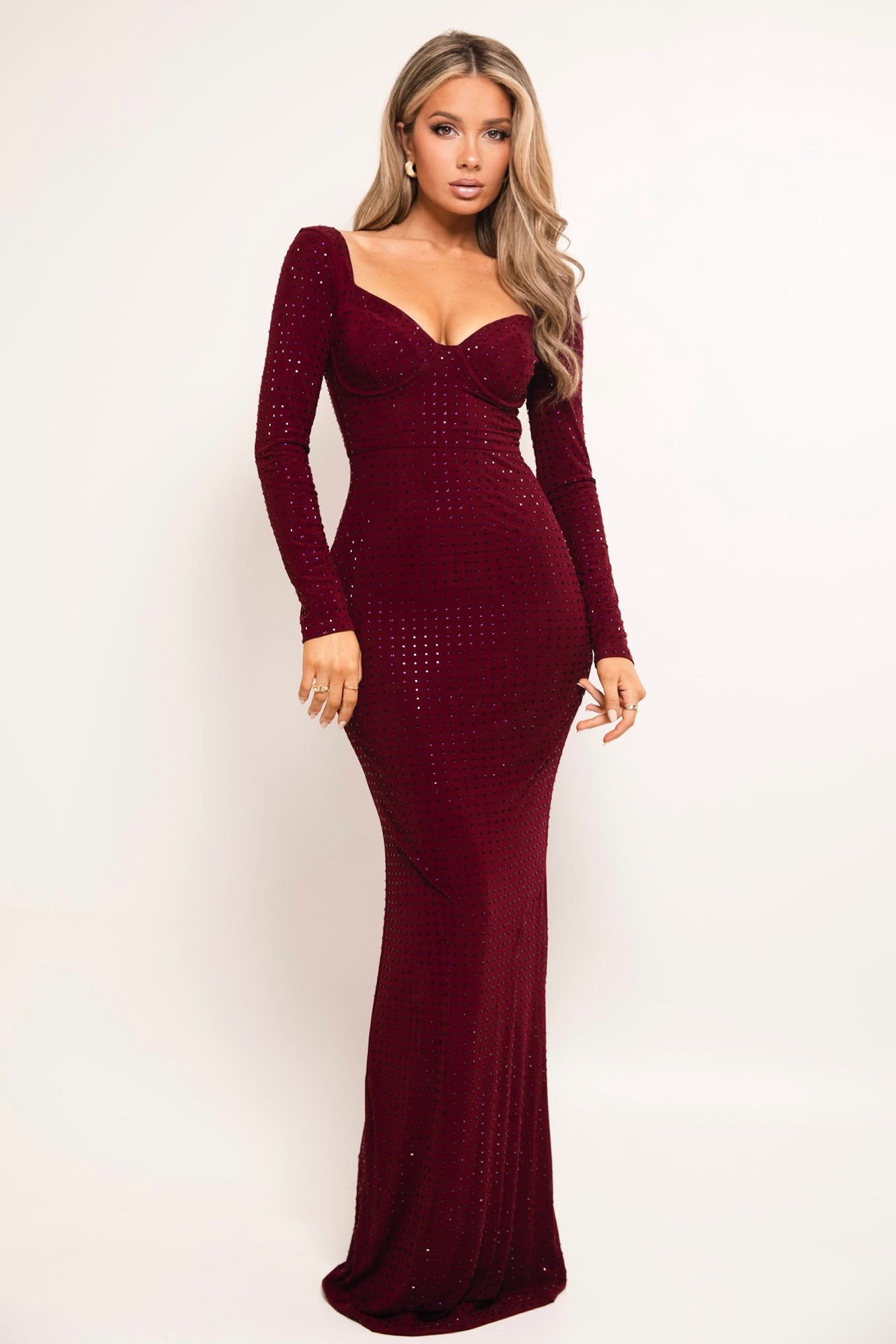 Burgundy sequin gown with long sleeves and a sweetheart neckline.