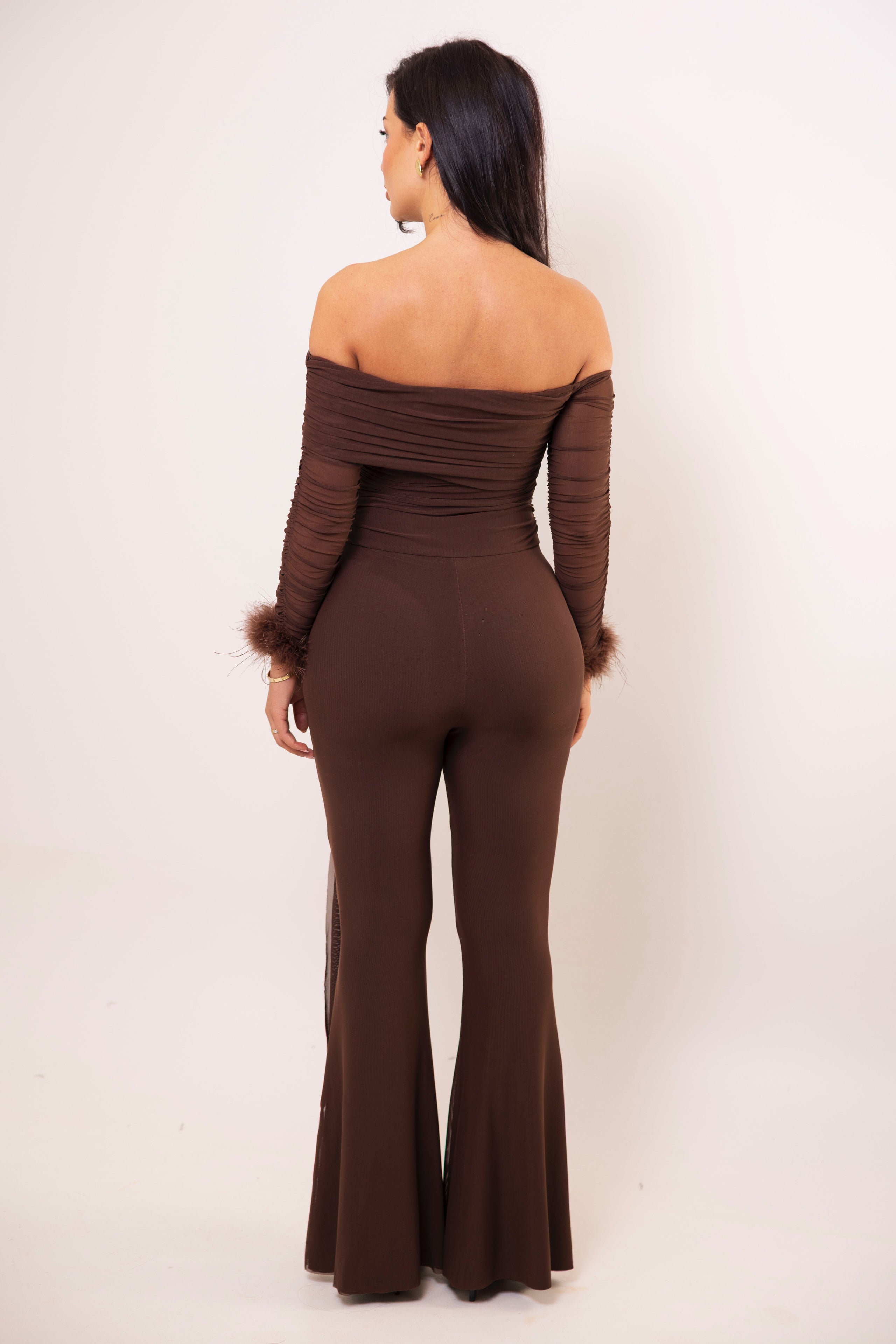 Sophisticated off-shoulder brown jumpsuit styled with gold jewelry.