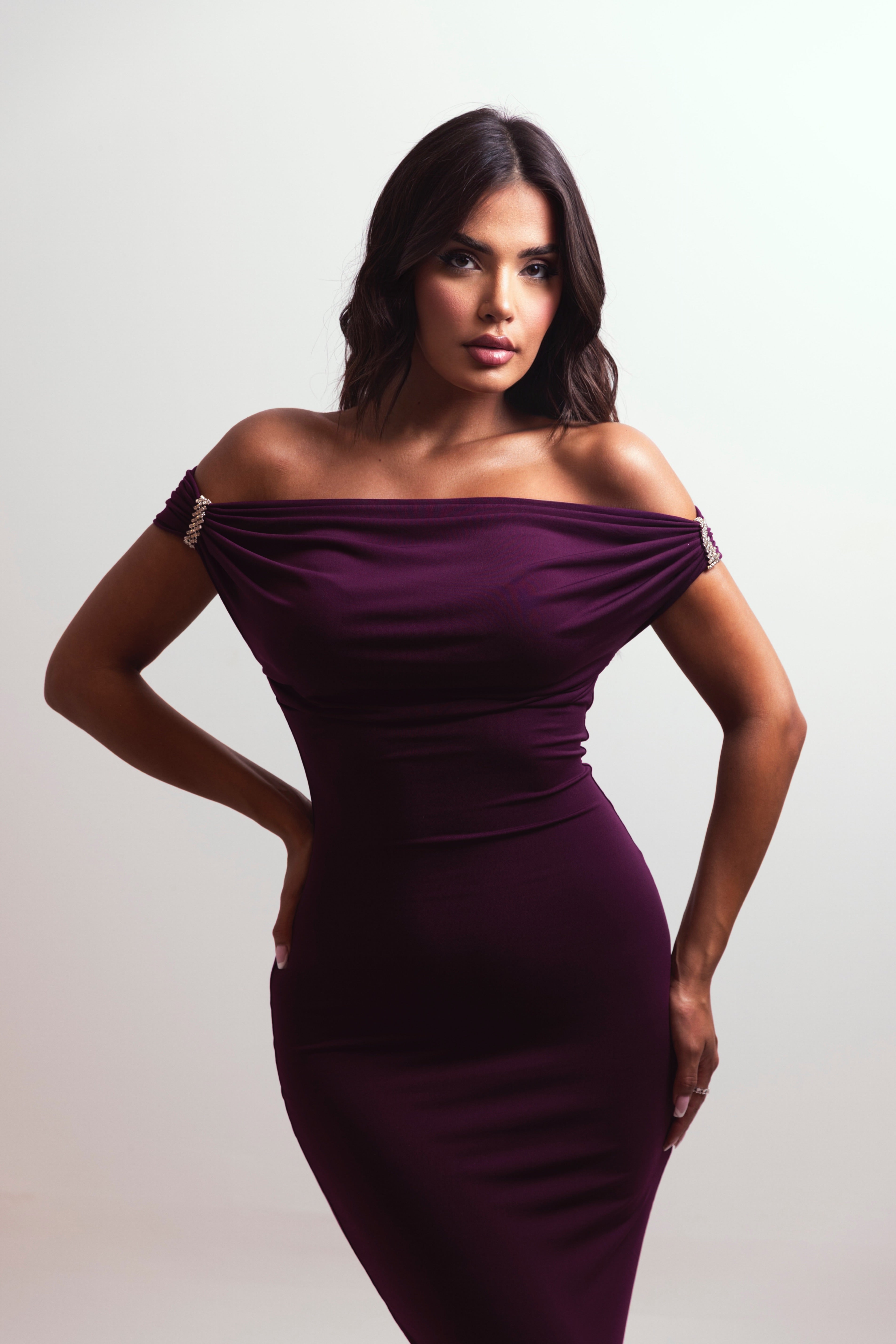 Sleek purple dress with sparkling shoulder pin