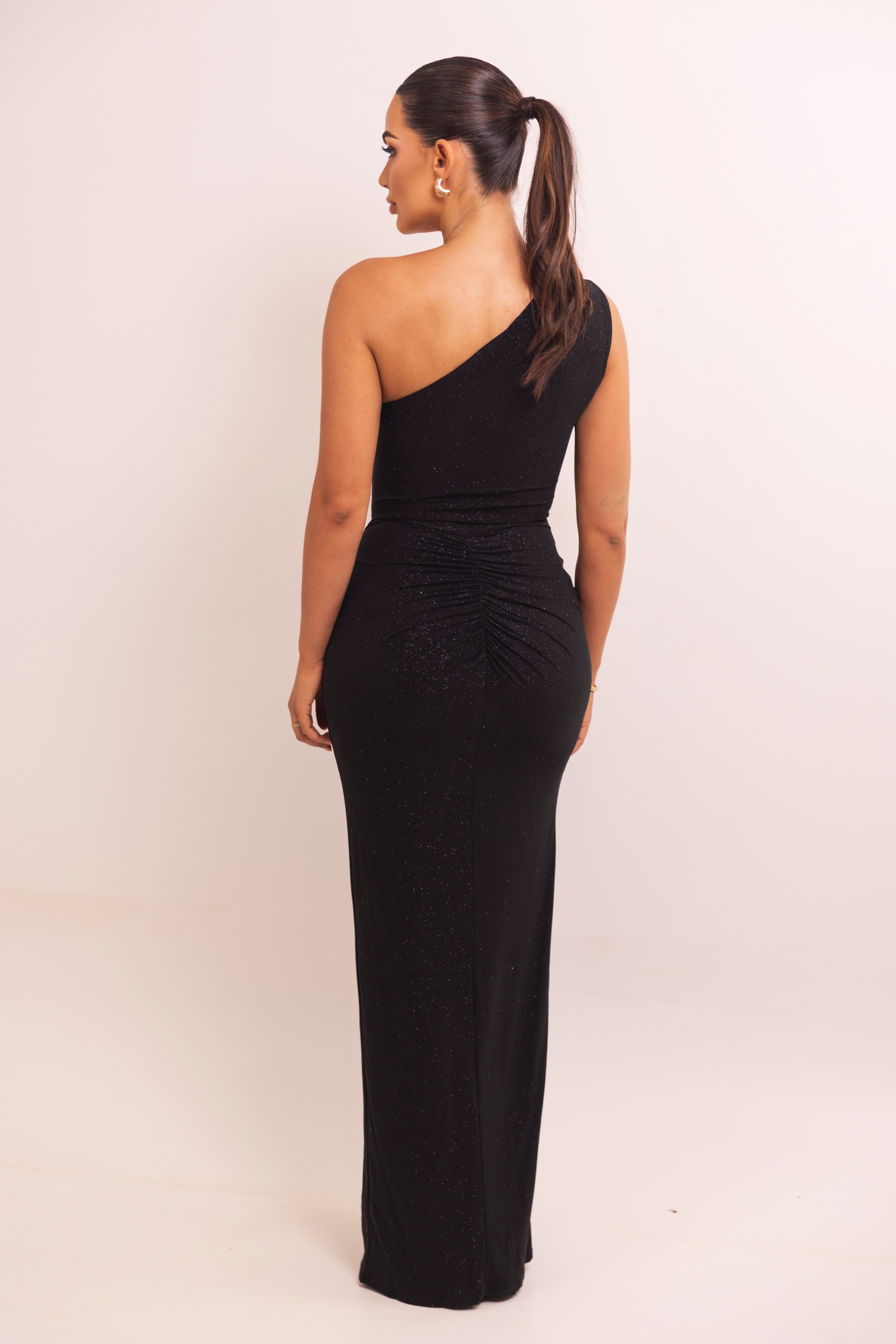 Elegant black evening dress featuring asymmetrical neckline and twist knot