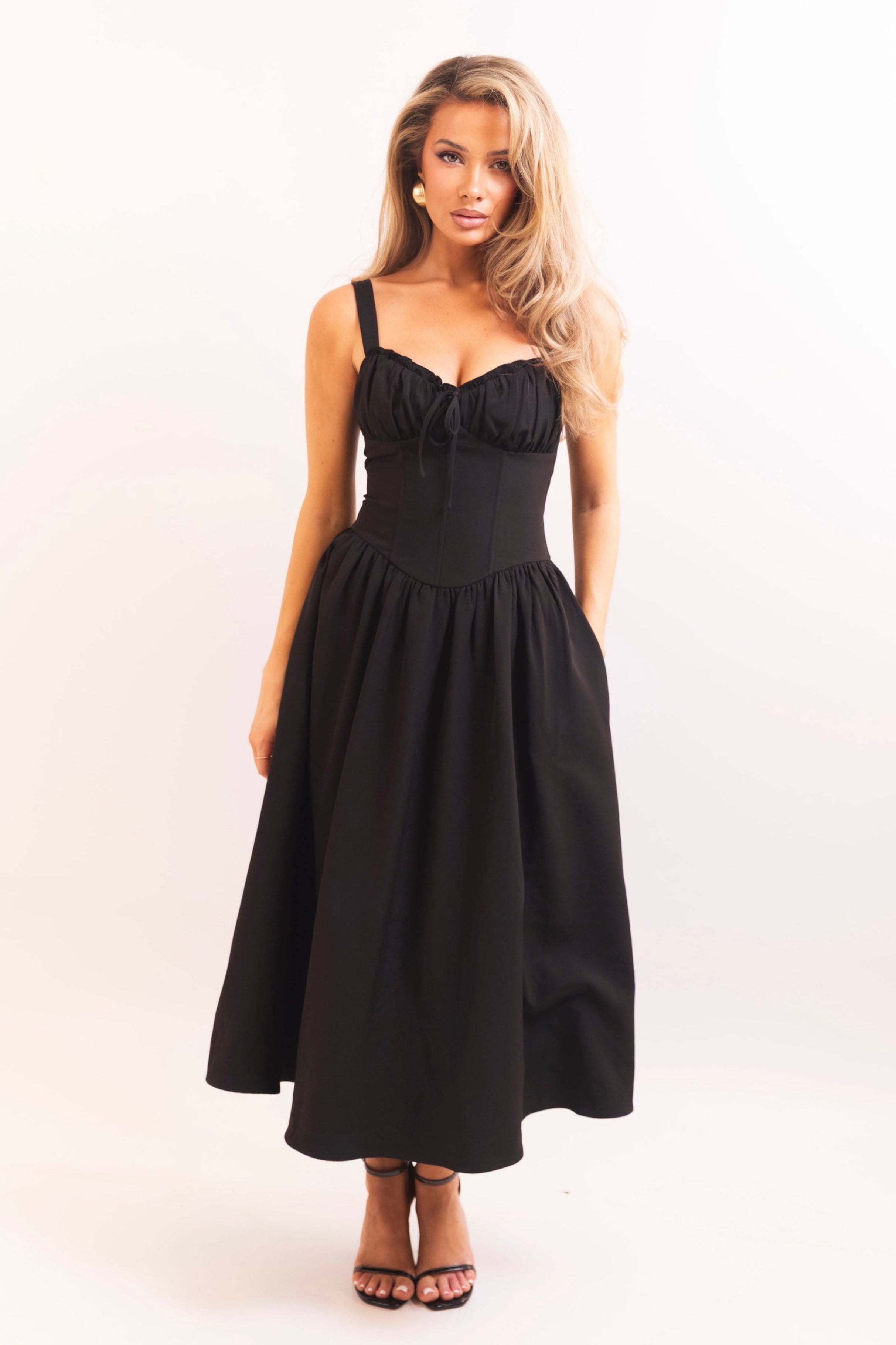 Ruffled bust black dress with delicate tie detail at the neckline