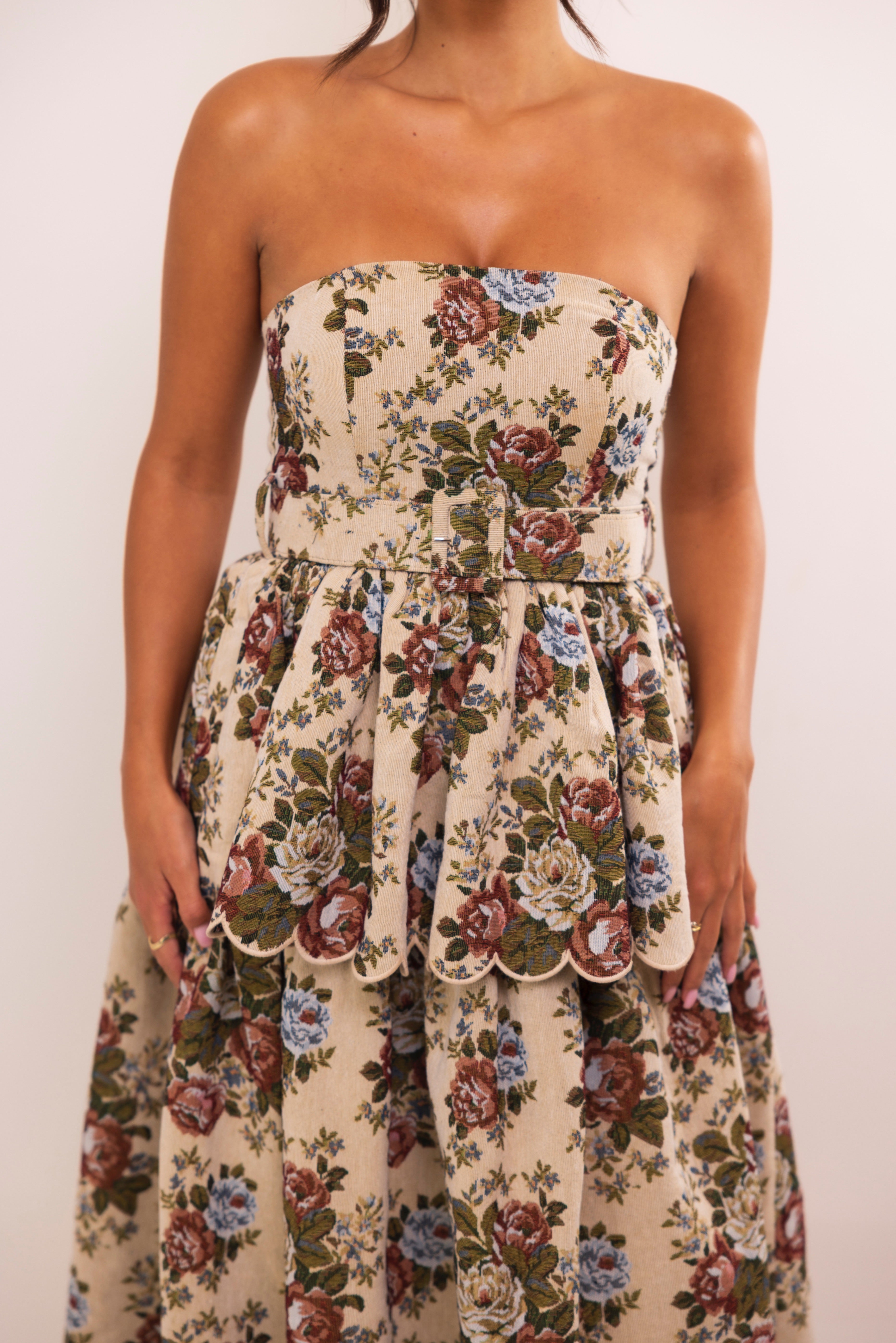 Romantic vintage-inspired beige floral dress with fitted waist and layered flared silhouette