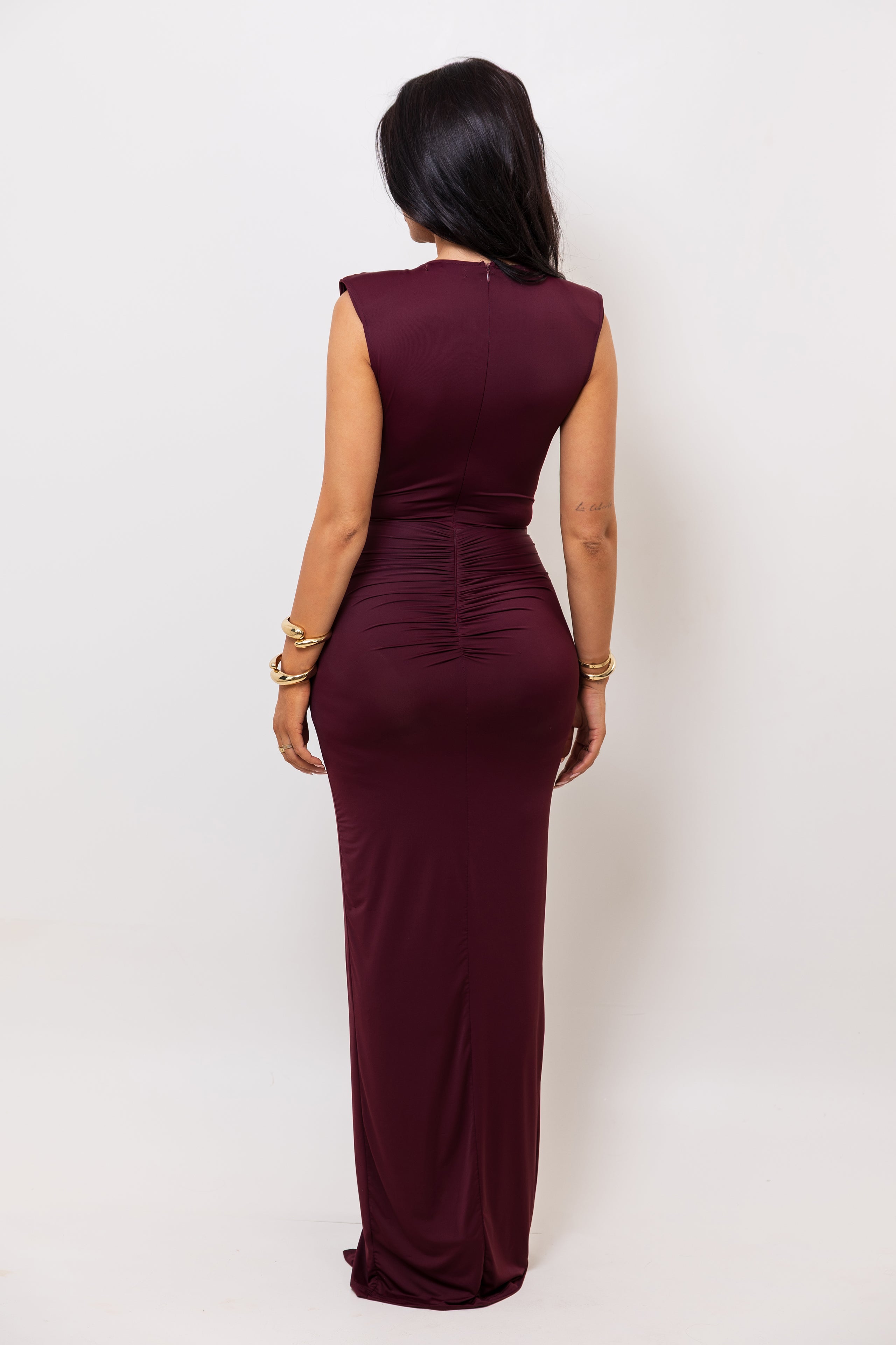 Woman wearing a burgundy dress against a white background