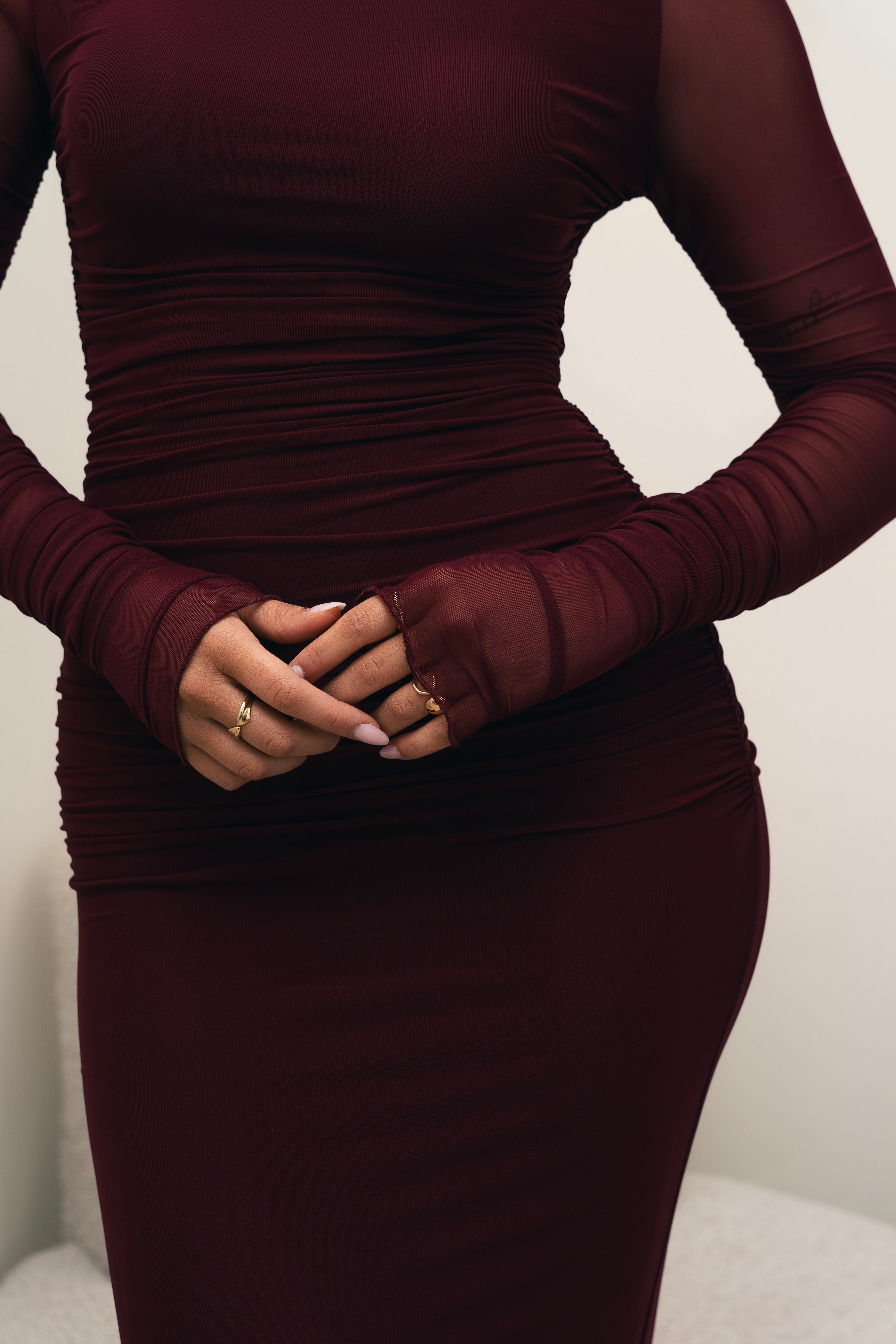 Form-fitting burgundy evening gown.