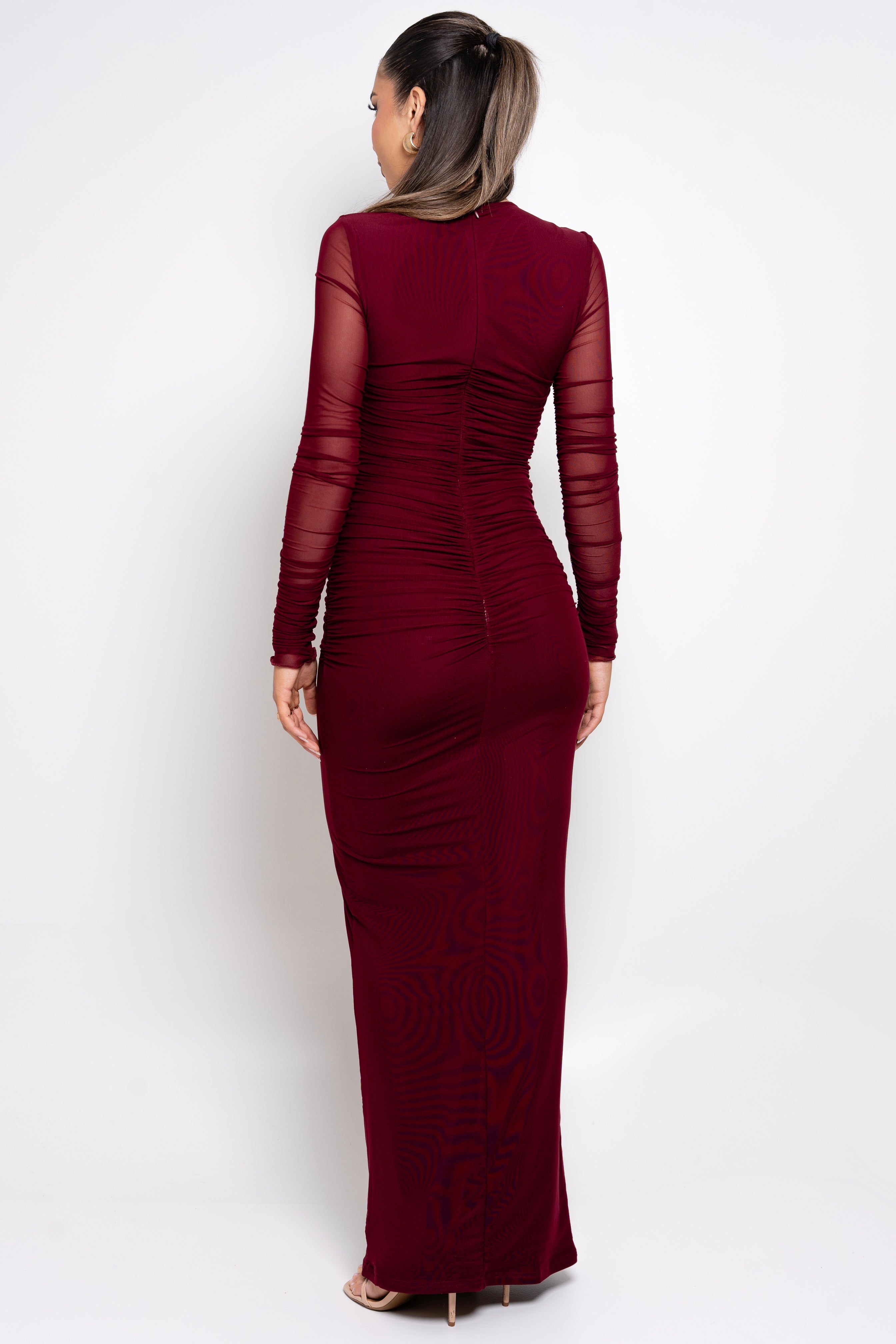 Floor-length ruched dress in dark red.