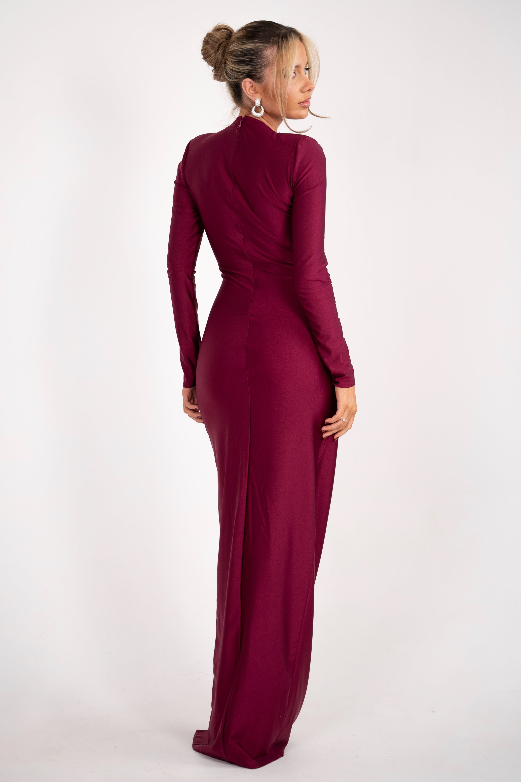 Deep red satin dress with an asymmetric draped design, a cut-out neckline, and a jeweled waist accent.