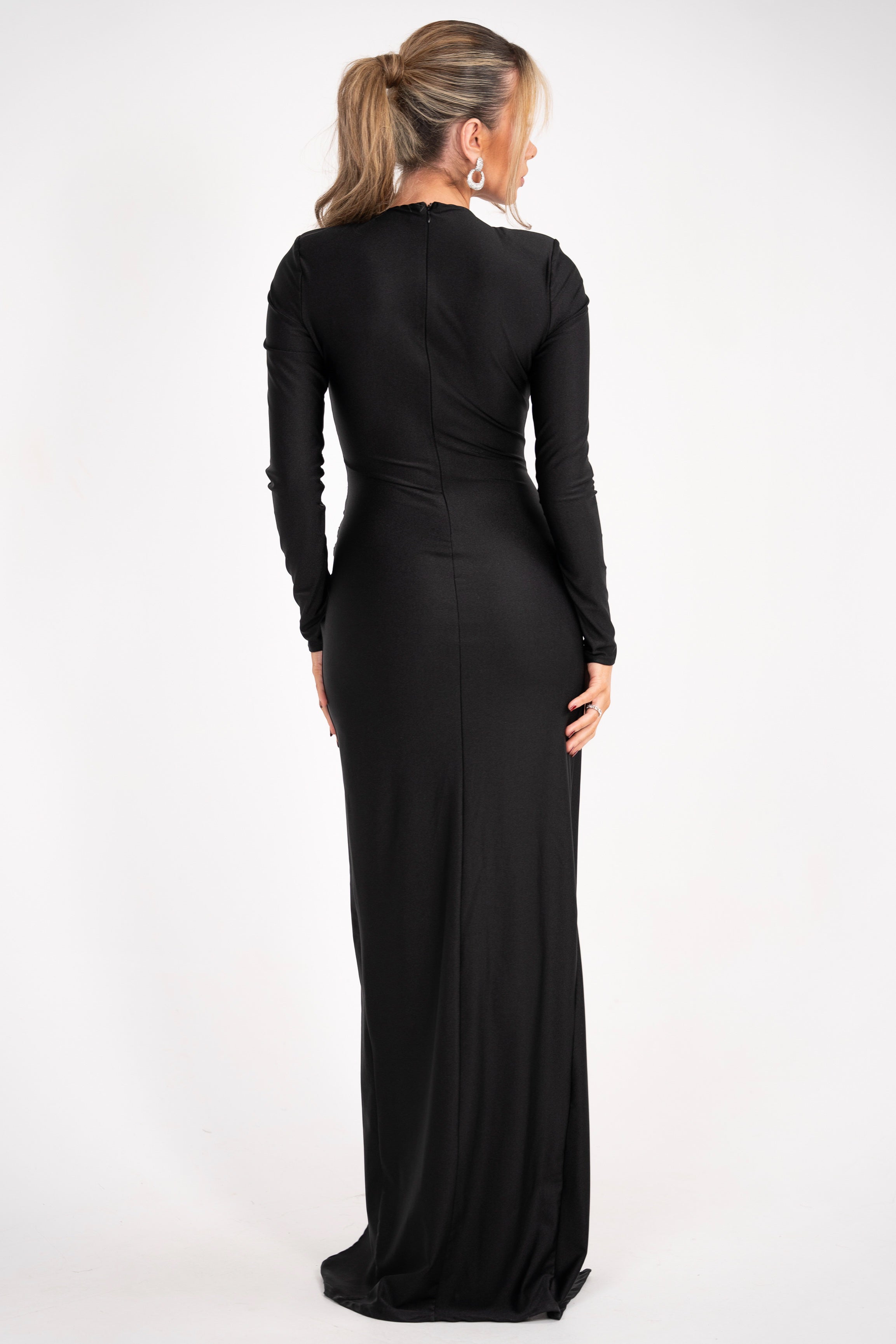 Sleek black evening dress with a draped skirt and crystal accent