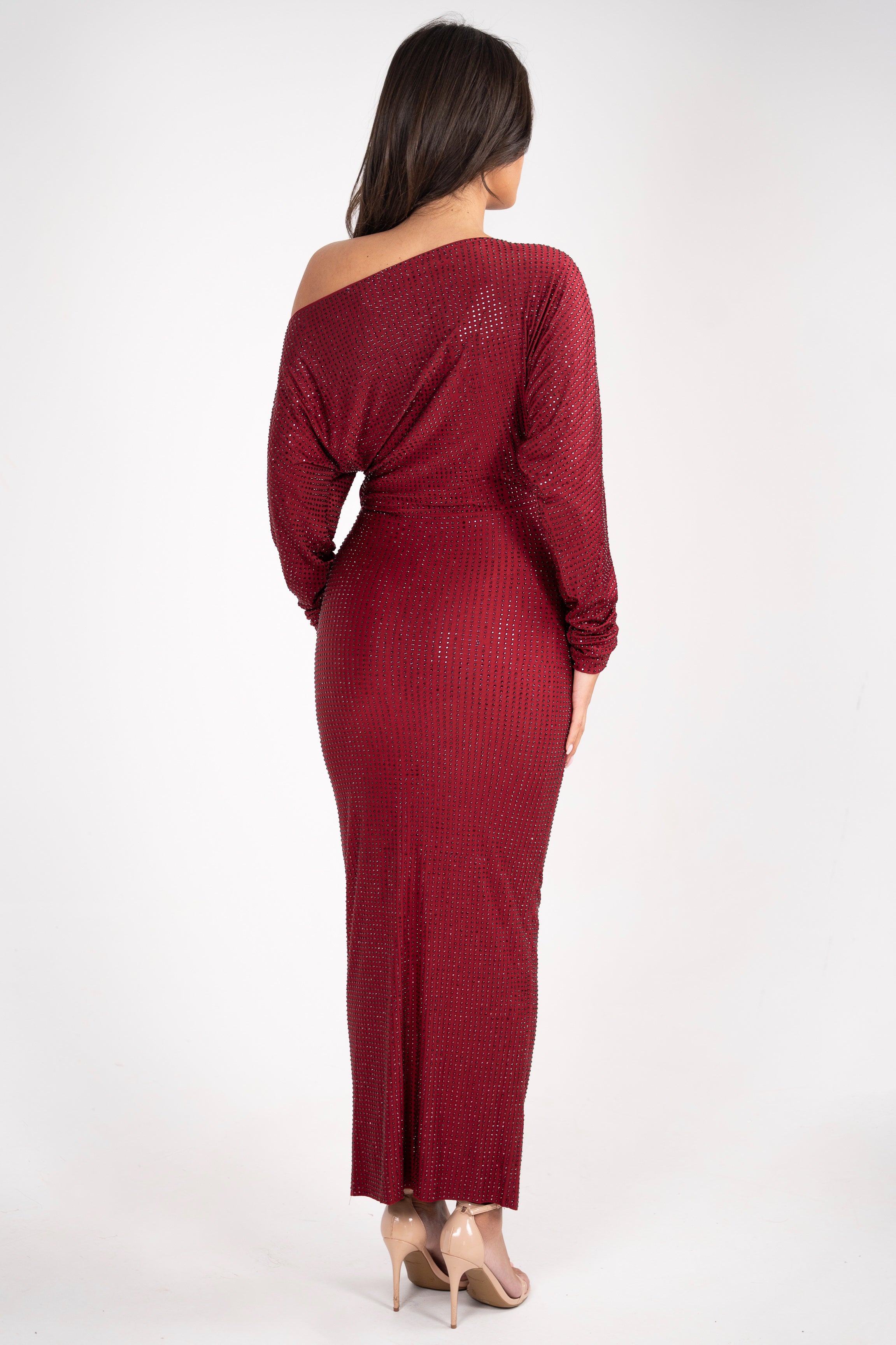 Full-length view of the burgundy dress, featuring rhinestone details, a ruched hip, and flowing sleeves