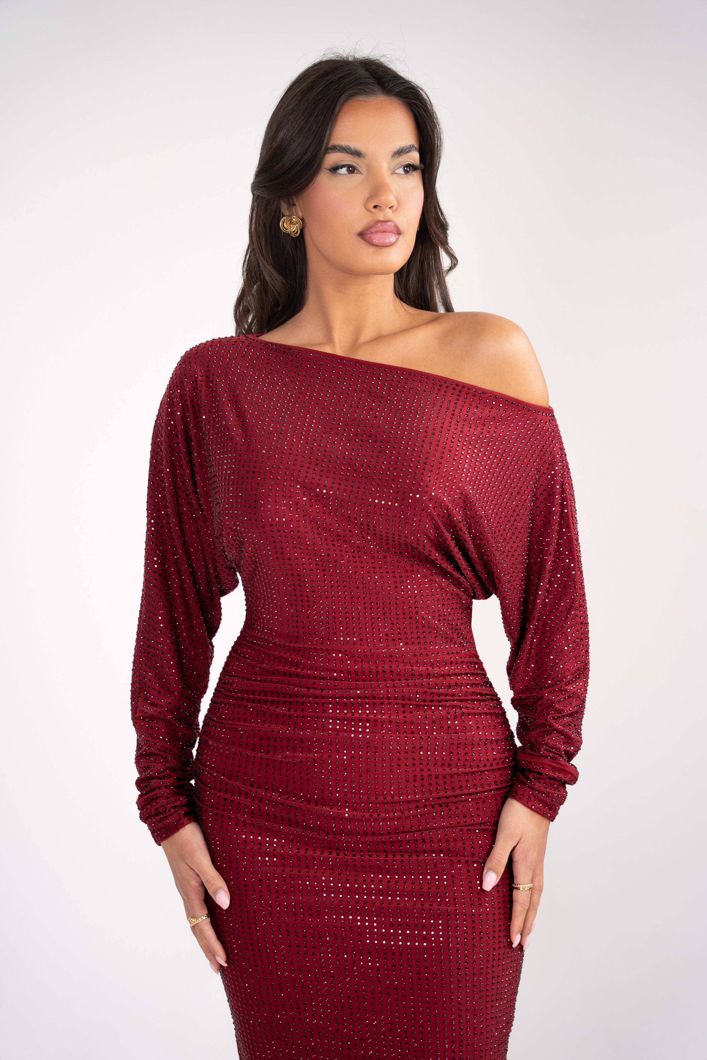 Front view of the burgundy dress with an asymmetrical upper part and loosely flowing sleeves for a graceful look.