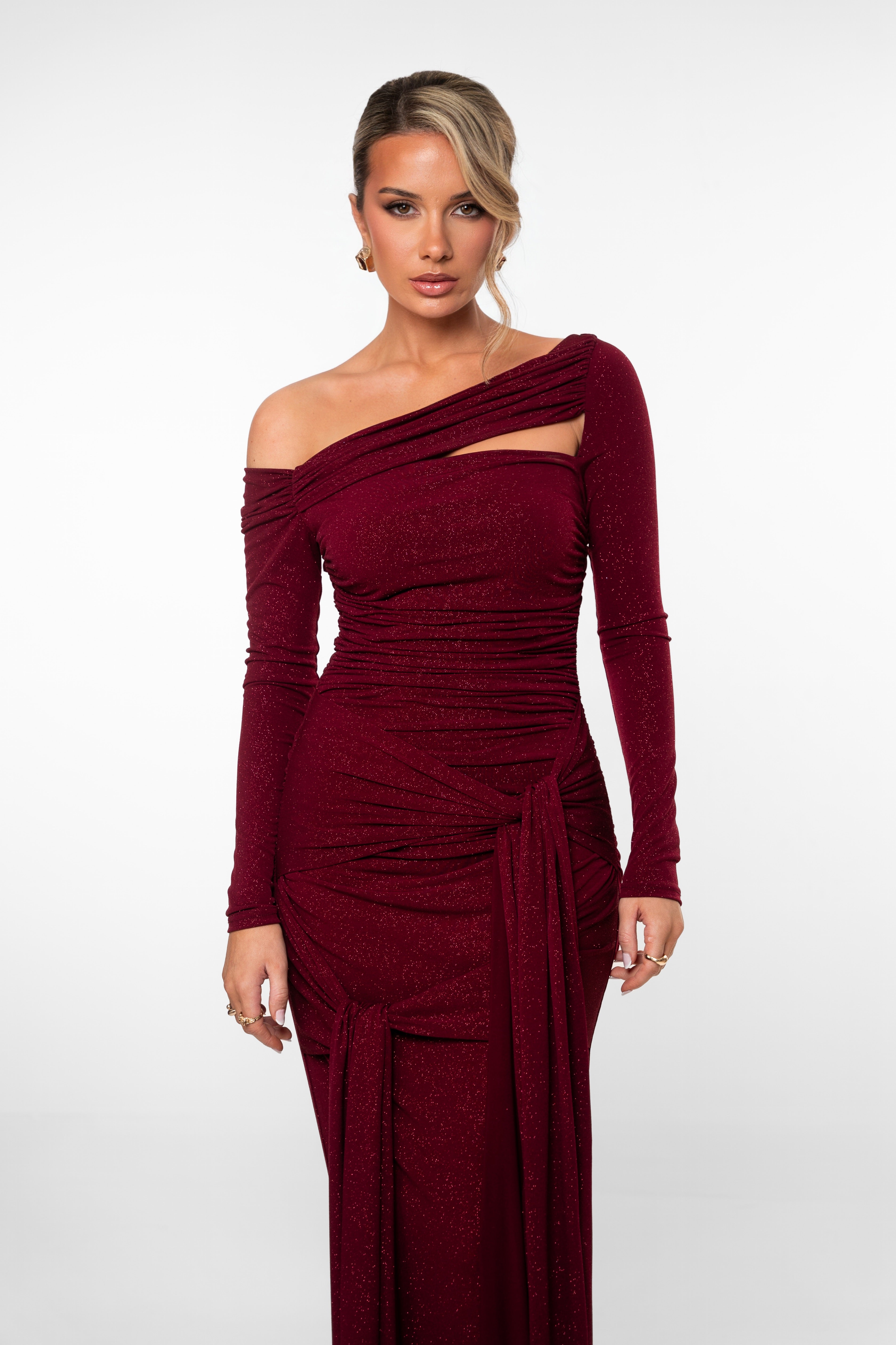 Woman wearing a burgundy off-shoulder dress on a white background