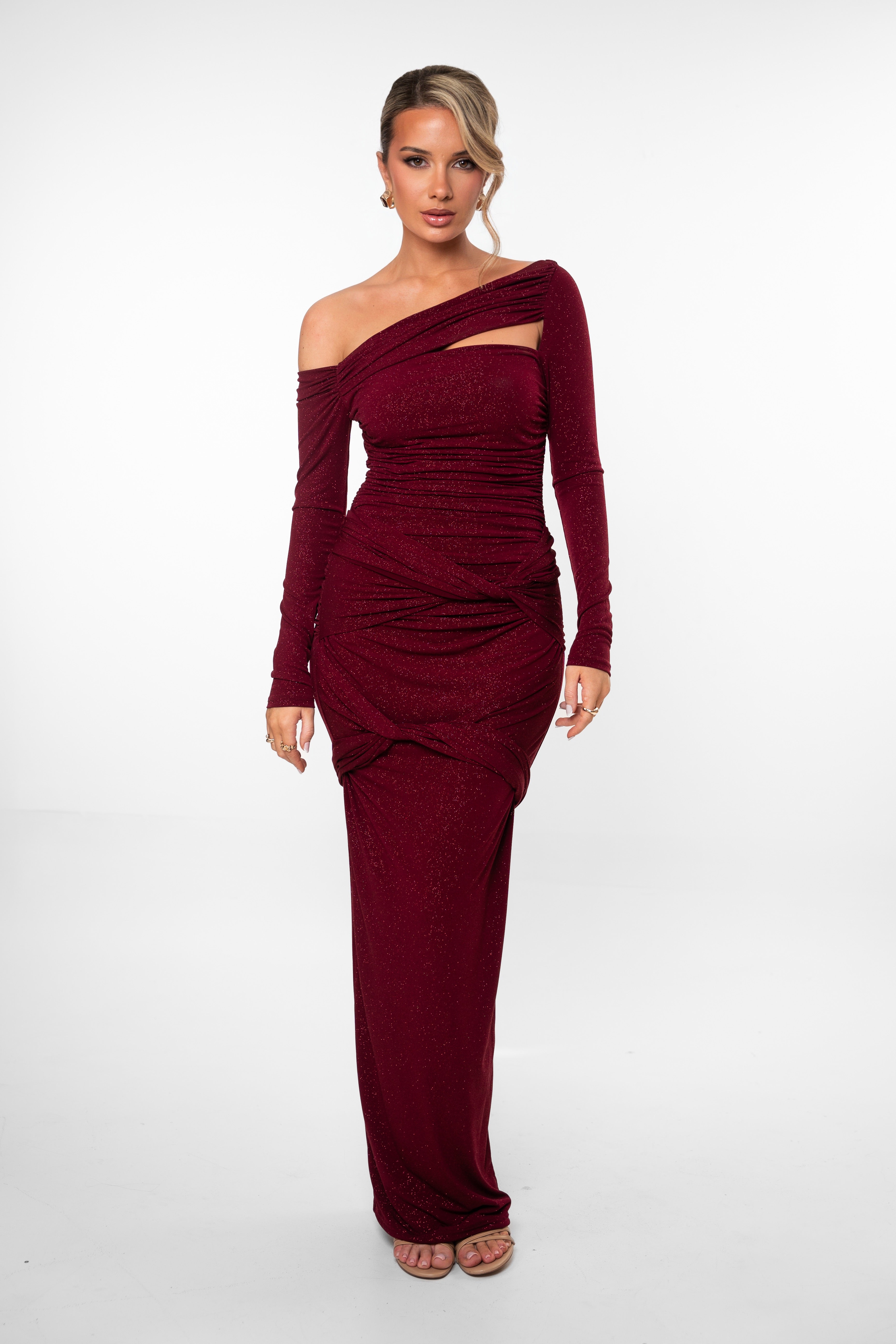 Woman wearing a burgundy off-shoulder dress on a white background