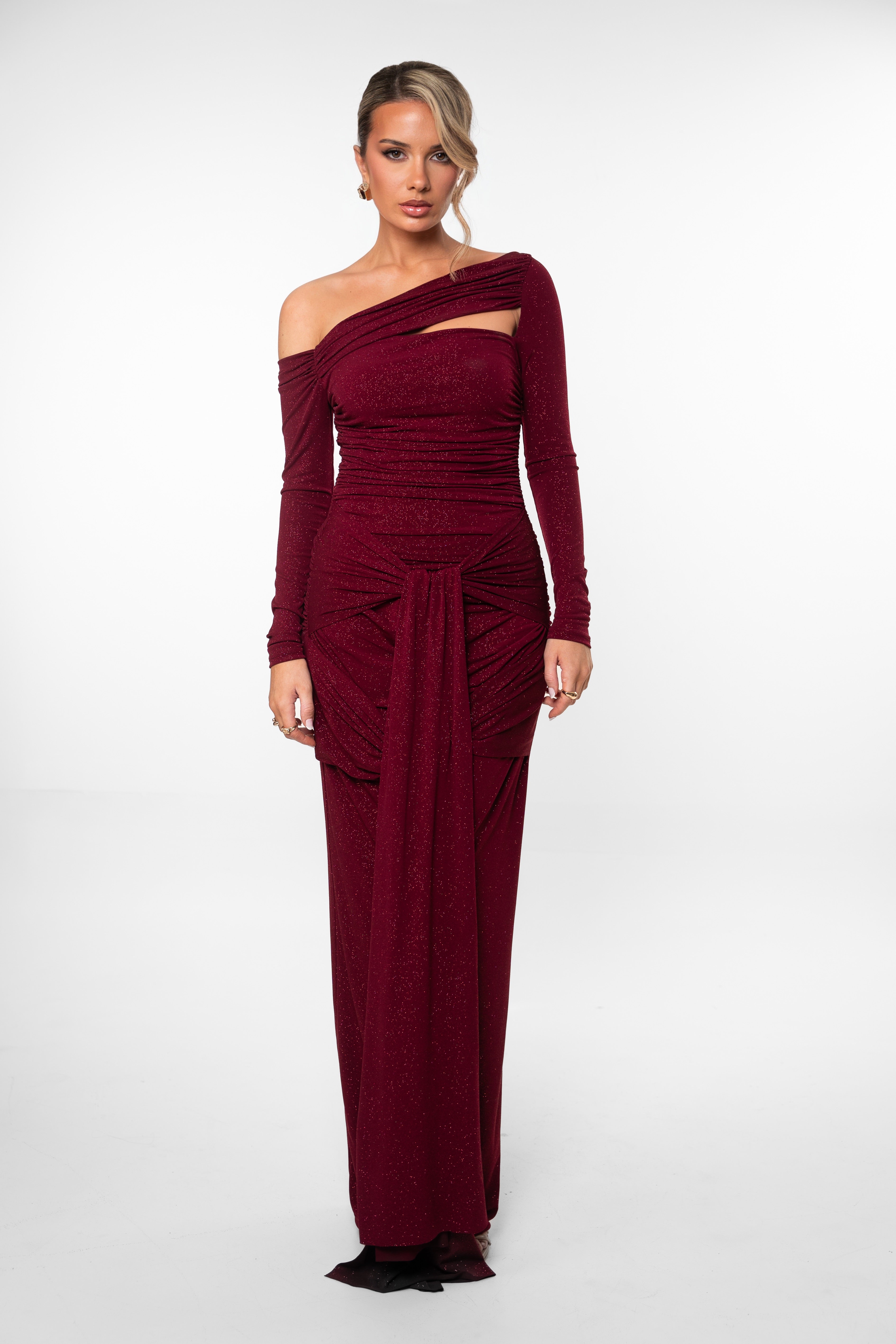 Woman wearing a burgundy off-shoulder dress on a white background