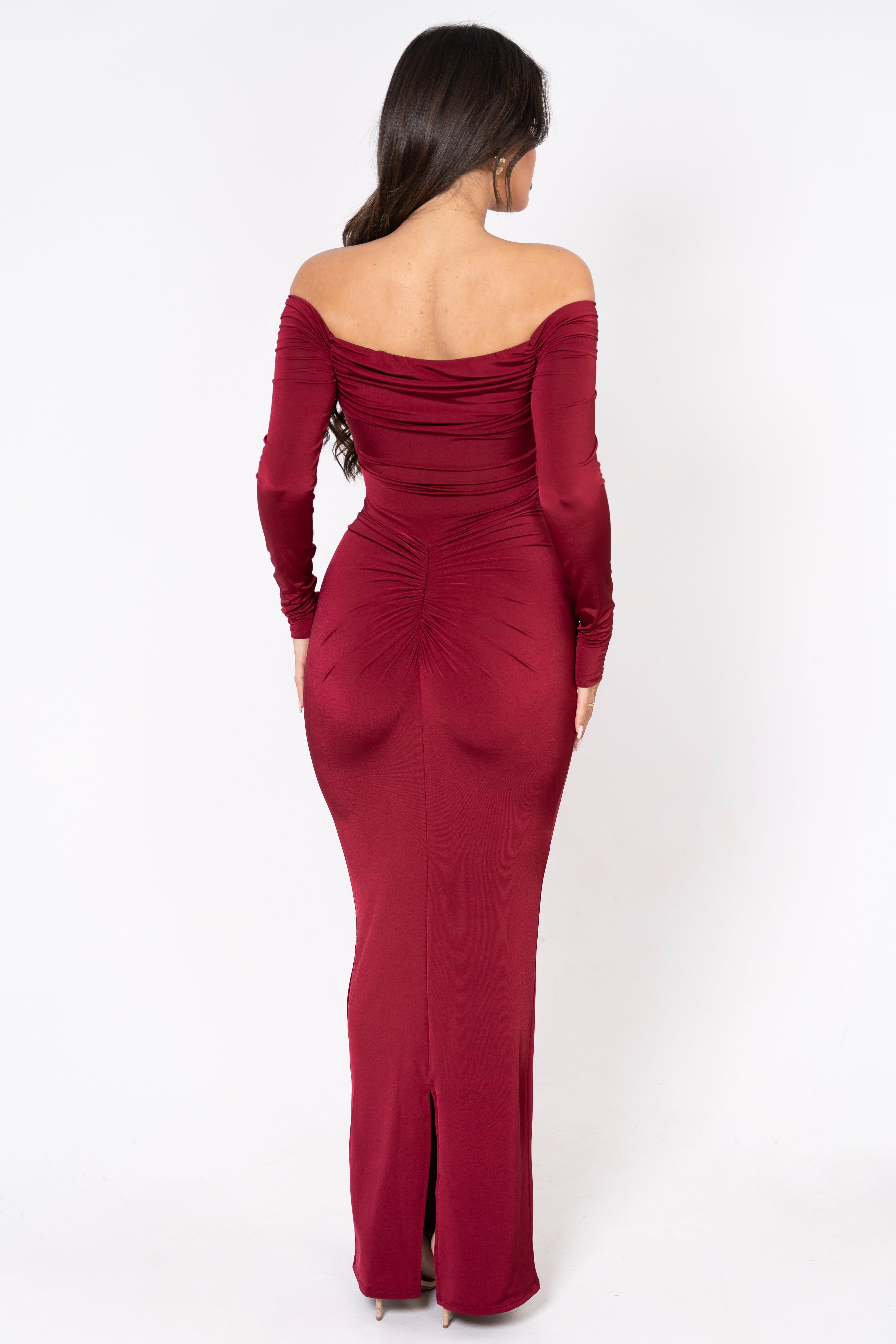 Rich burgundy gown with long sleeves and a statement draped waist