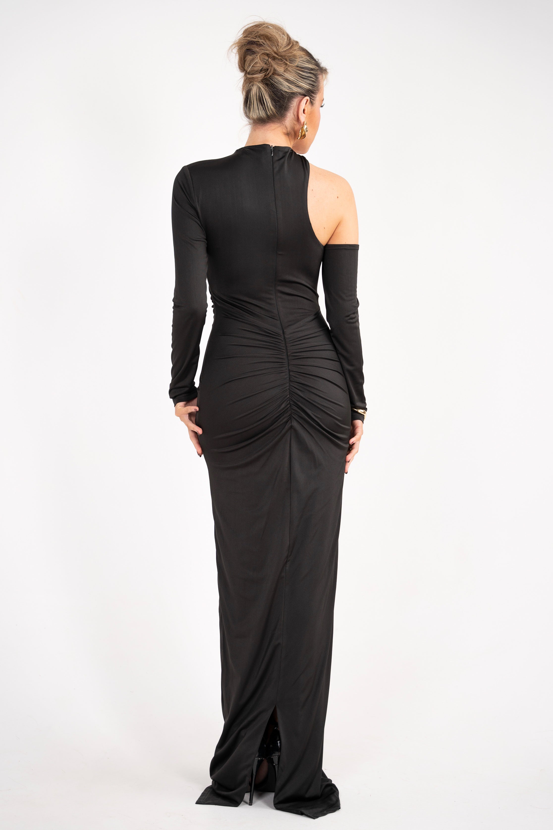 Modern black maxi dress featuring a unique off-the-shoulder cut and ruched waist for a flattering fit.