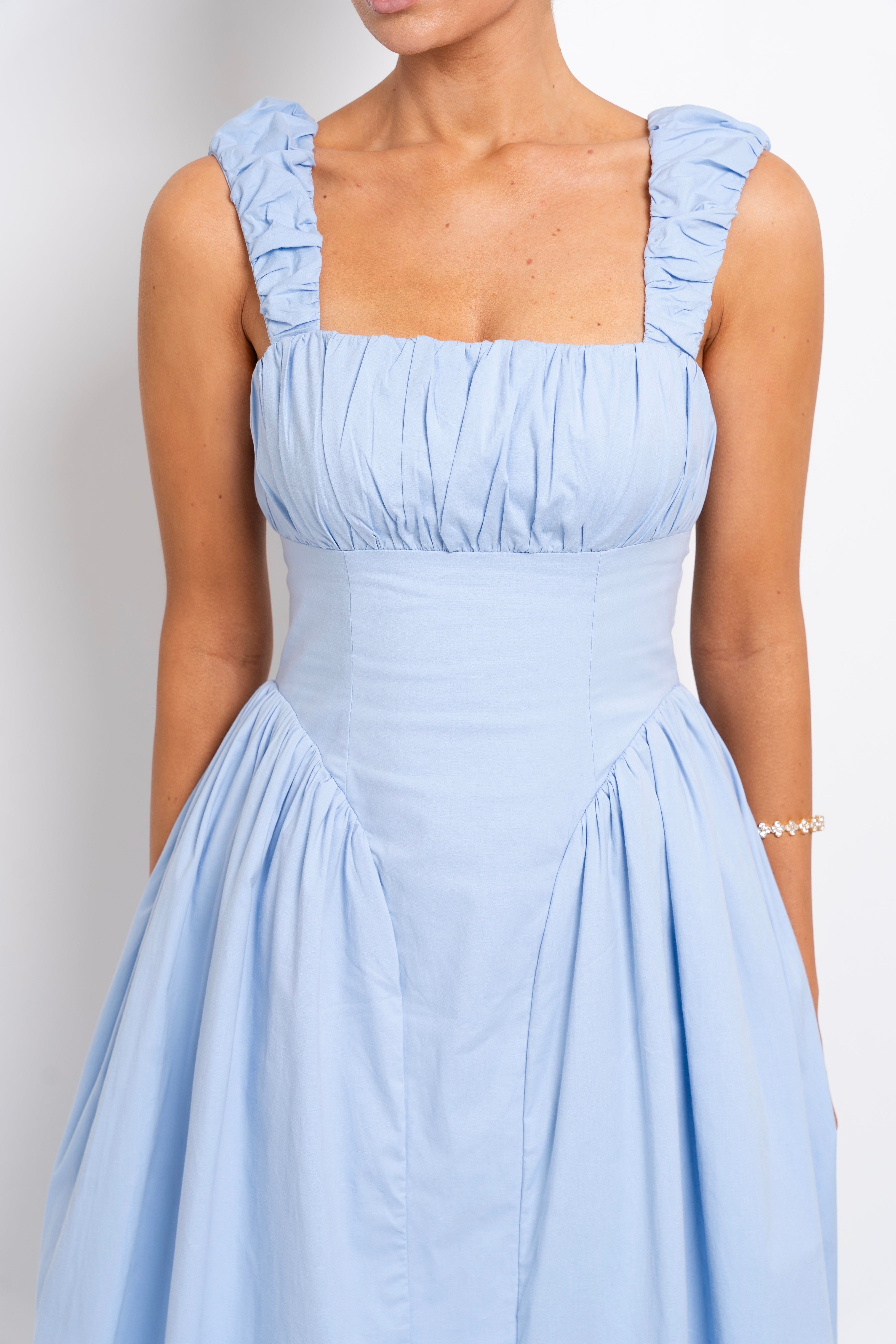 Elegant pastel blue dress with a fitted bodice.