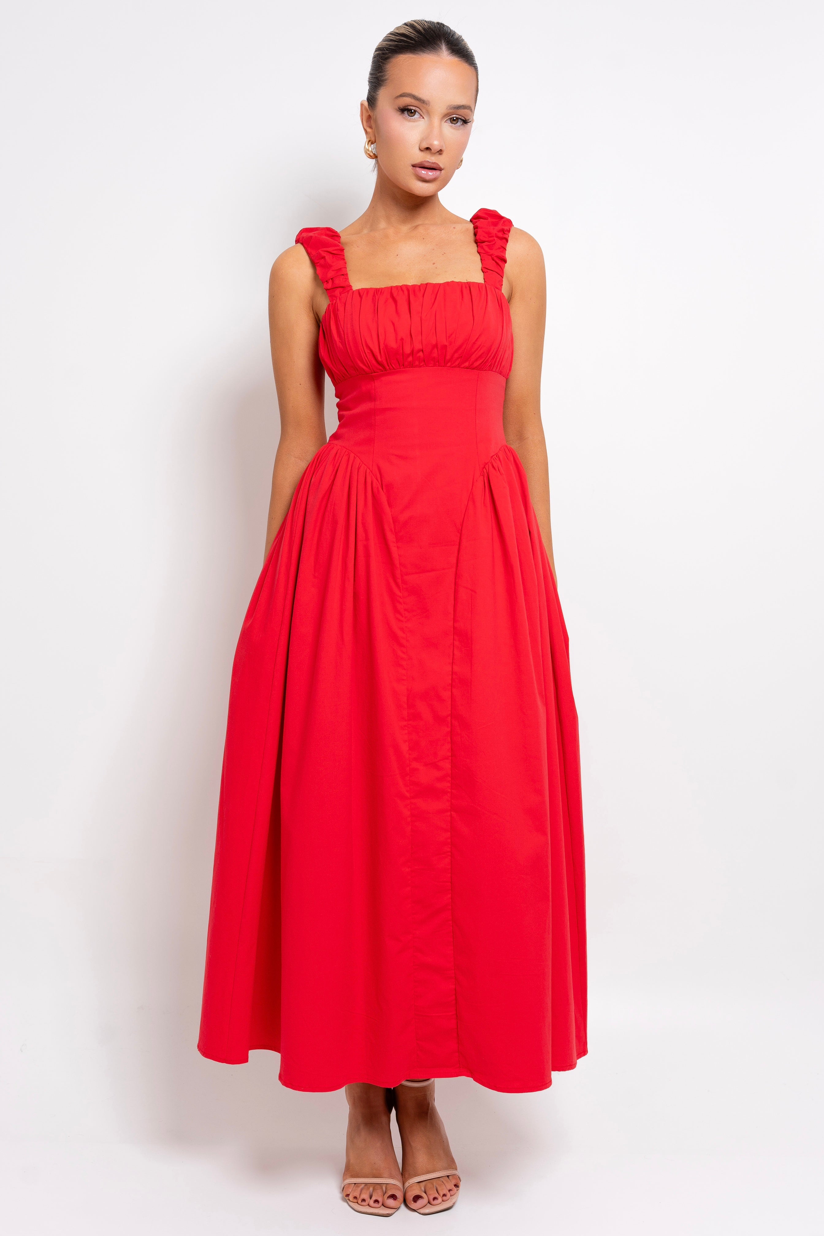 Feminine ruffled-strap dress in striking red.