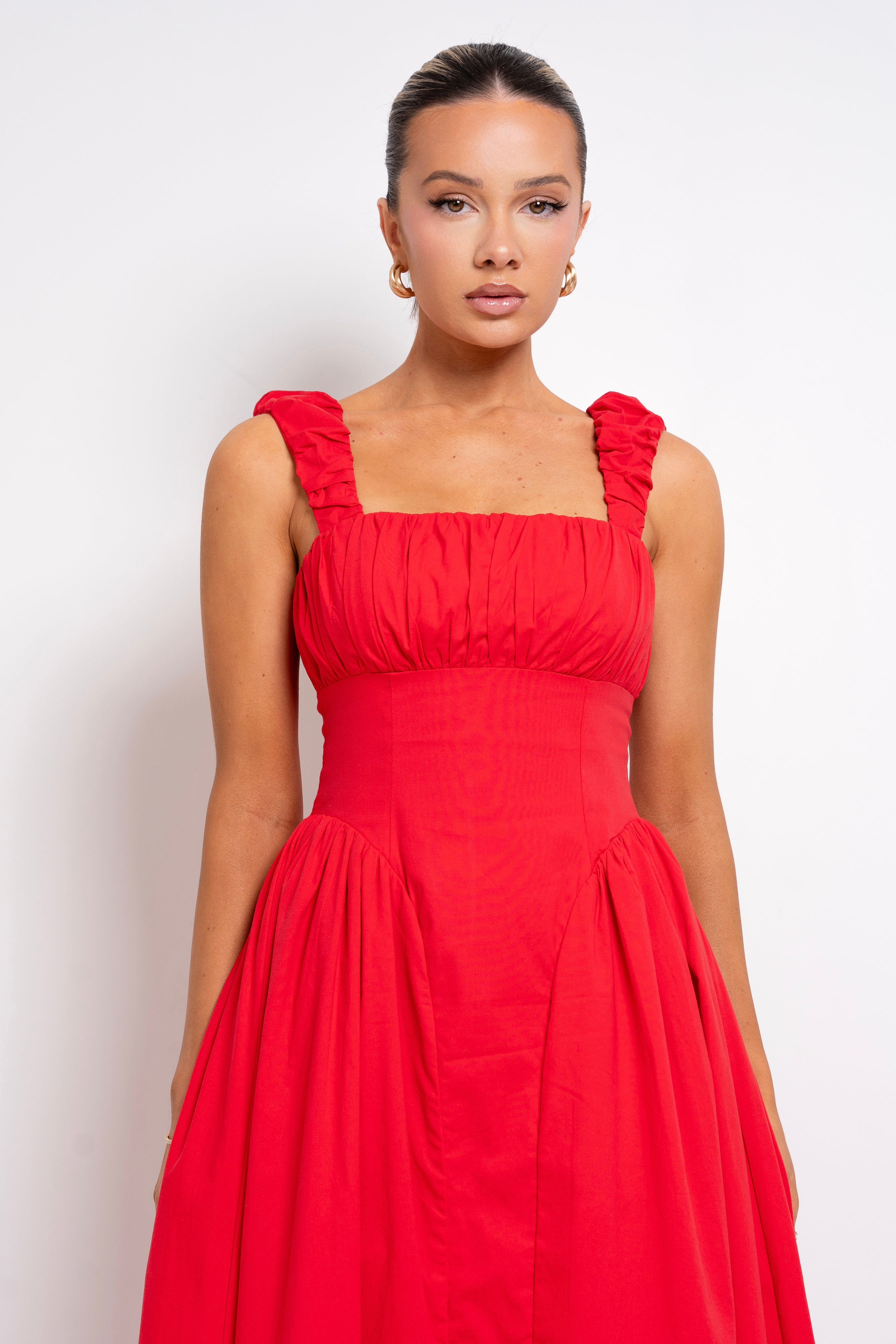 Vibrant red maxi dress with ruffled straps.