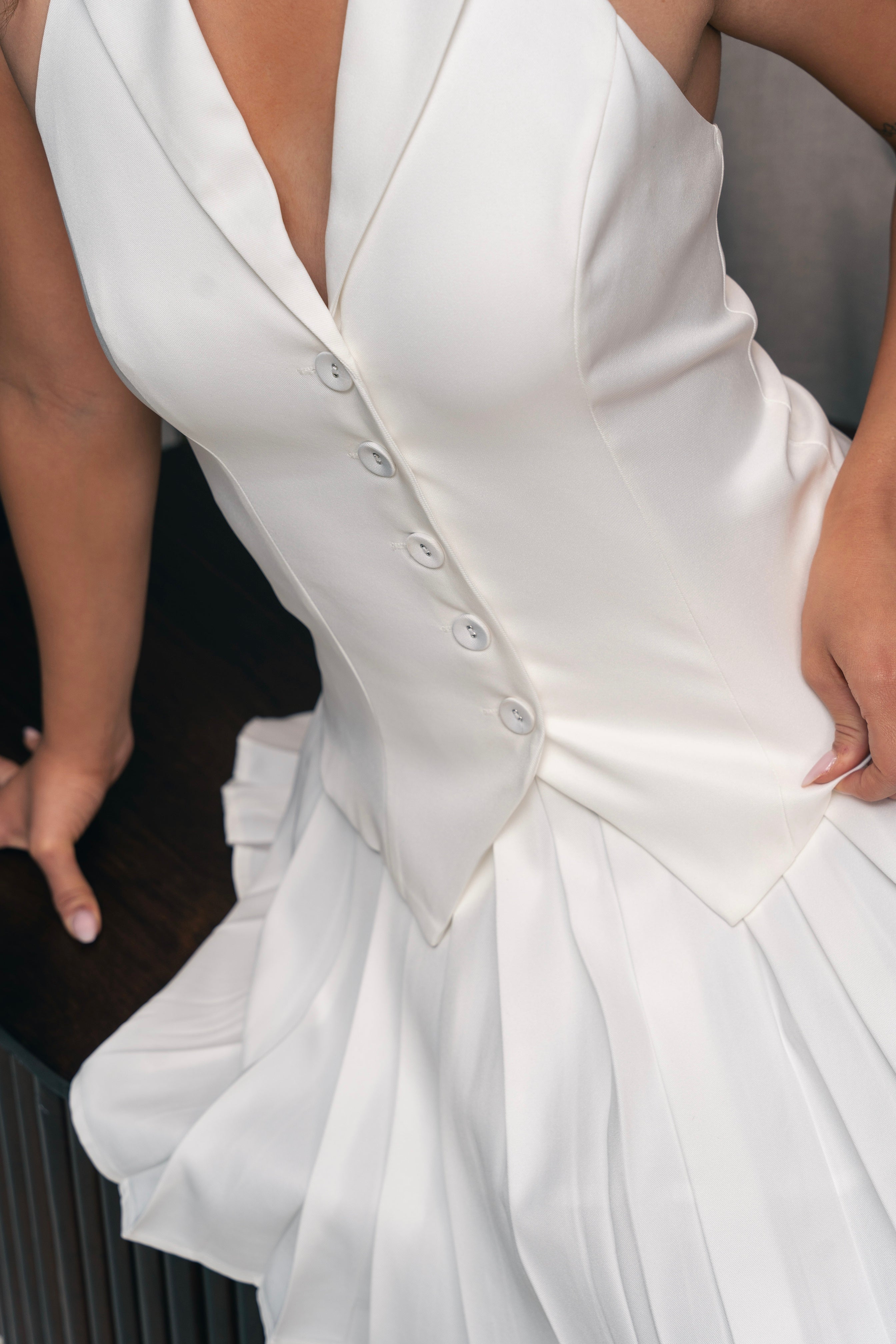 Elegant white tailored dress with a structured bodice.